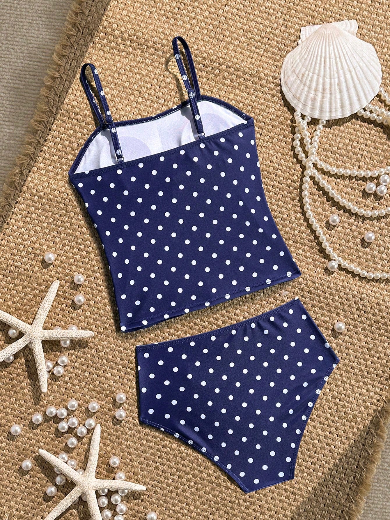 Tween girls 2-piece bikini swimwear set in black with a wave-pattern geometric design, featuring halter neckline, wireless top, and high-waist short bottoms with starfish and shell decor.