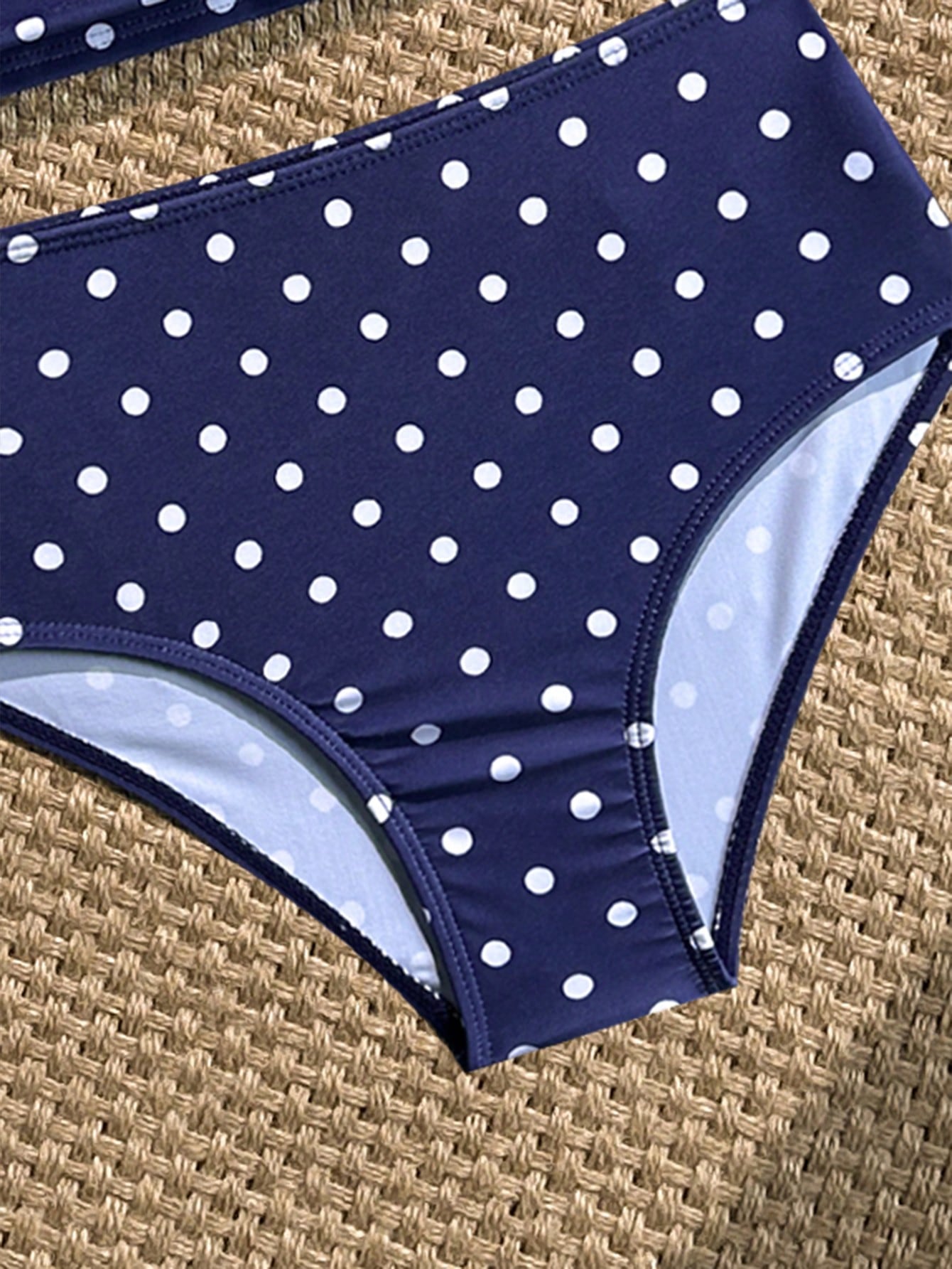 Tween girls 2-piece bikini swimwear set in black with a wave-pattern geometric design, featuring halter neckline, wireless top, and high-waist short bottoms with starfish and shell decor.
