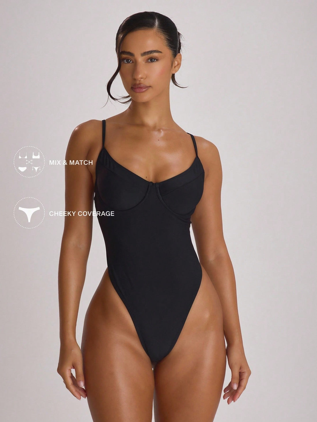 Women's solid color high leg backless one-piece swimsuit featuring removable padding and buckle detail.