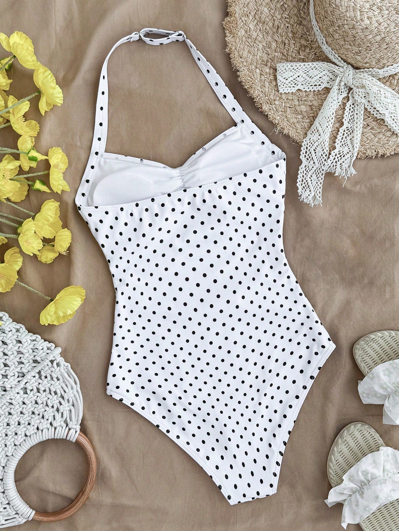 Tween girls one-piece swimsuit with polka dot-inspired all-over print, bow detail, spaghetti strap halter neckline, and lined stretch fabric for beach or vacation wear