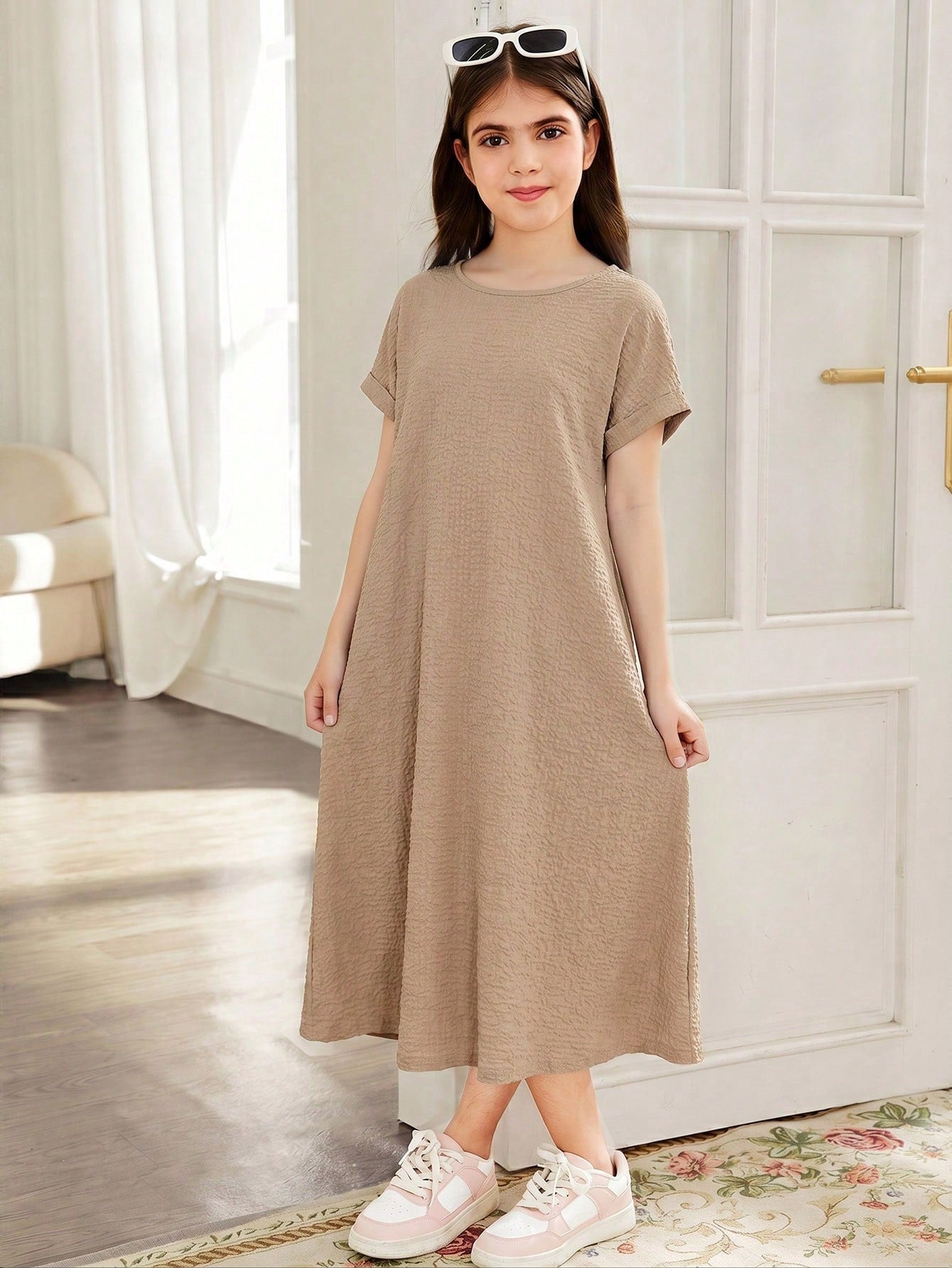 Tween girls casual black A-line long dress featuring short sleeves, a round neckline, and a decorative front bow with contrast lace trim.