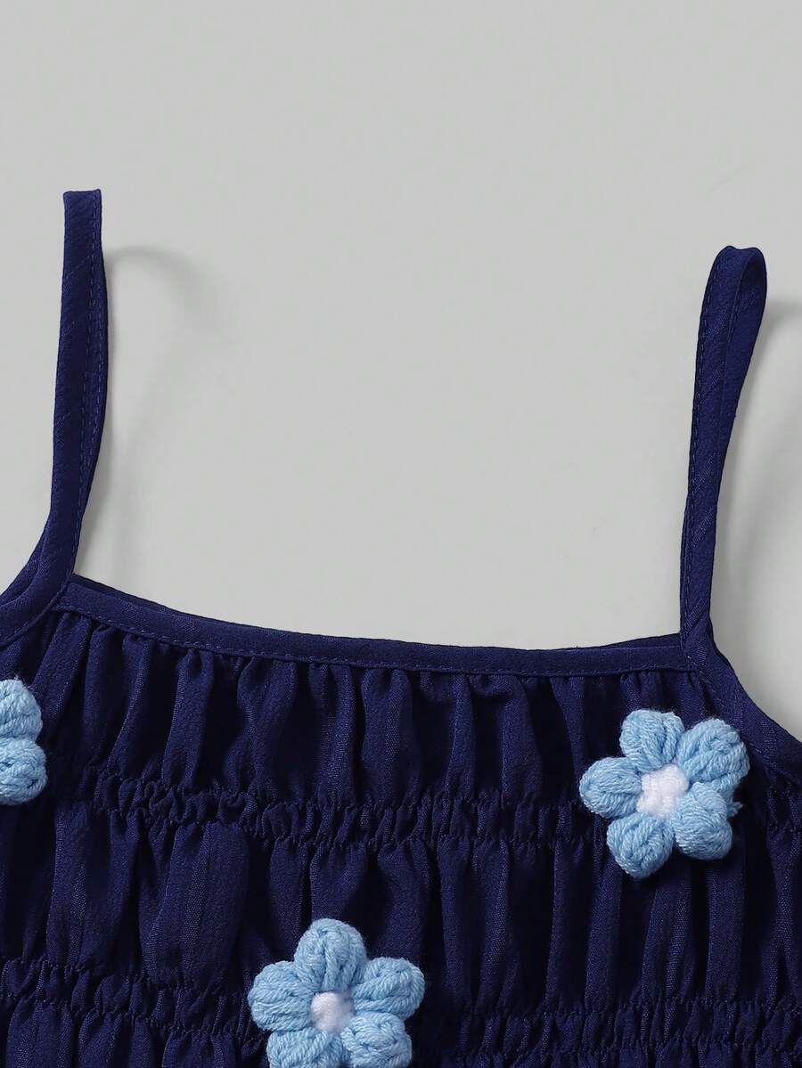 Girls 2-piece summer outfit set featuring a blue bow print camisole top with spaghetti straps and matching high-waisted straight leg pants.