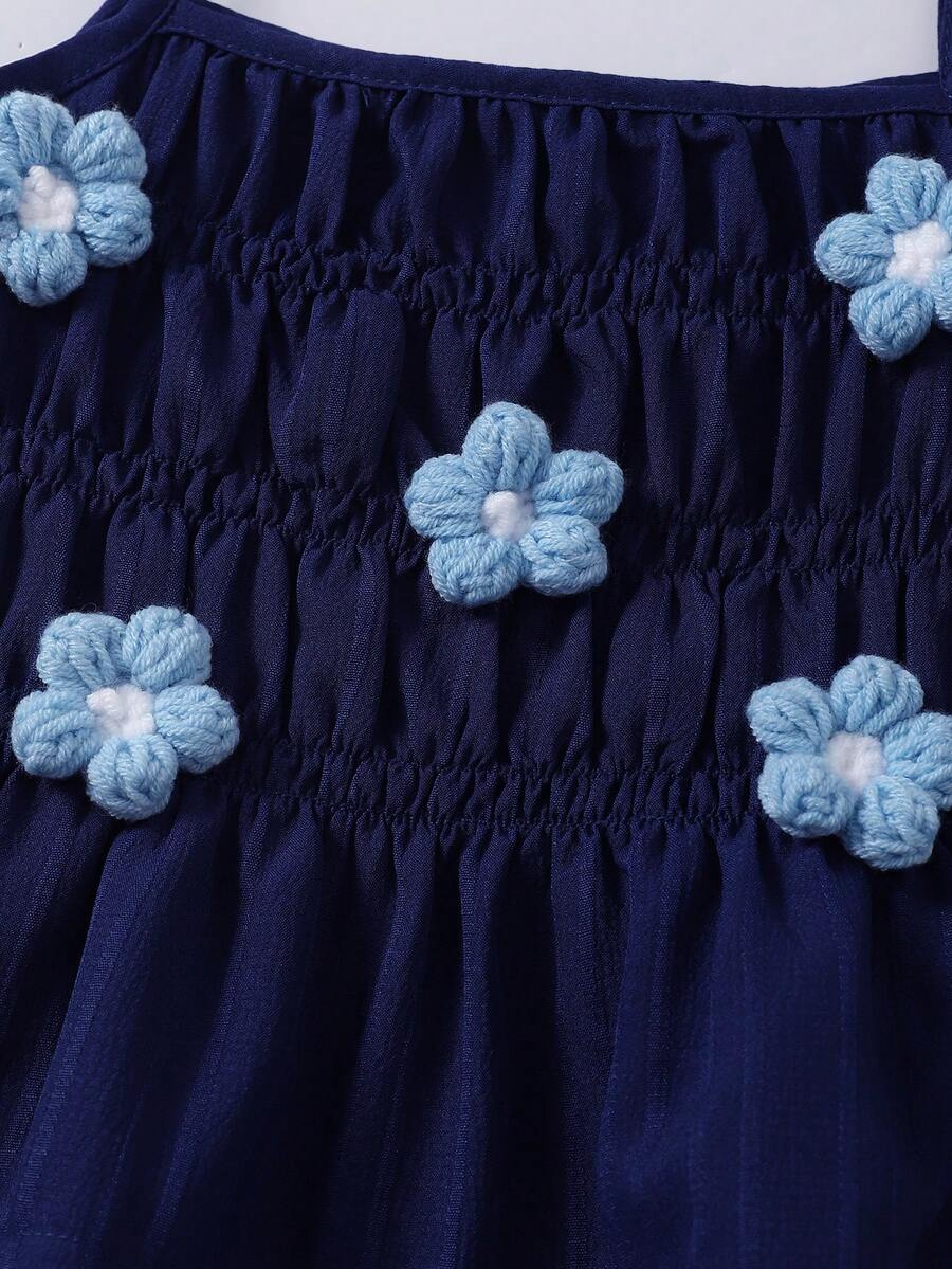 Girls 2-piece summer outfit set featuring a blue bow print camisole top with spaghetti straps and matching high-waisted straight leg pants.