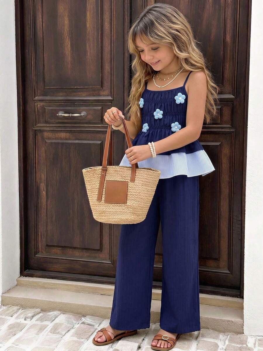 Girls 2-piece summer outfit set featuring a blue bow print camisole top with spaghetti straps and matching high-waisted straight leg pants.