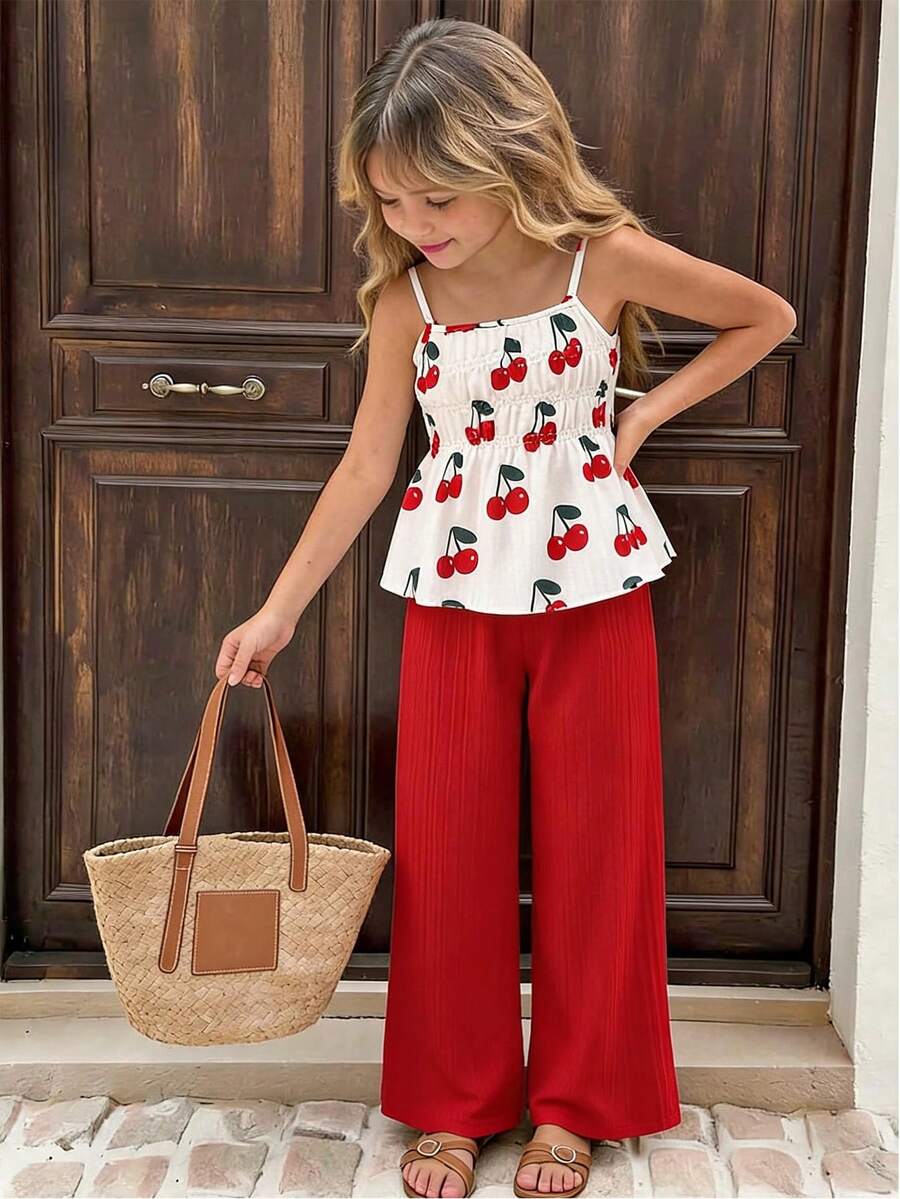 Girls 2-piece summer outfit set featuring a blue bow print camisole top with spaghetti straps and matching high-waisted straight leg pants.