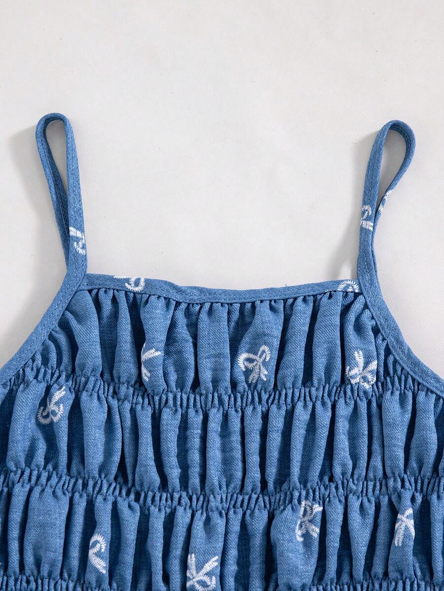 Girls 2-piece summer outfit set featuring a blue bow print camisole top with spaghetti straps and matching high-waisted straight leg pants.
