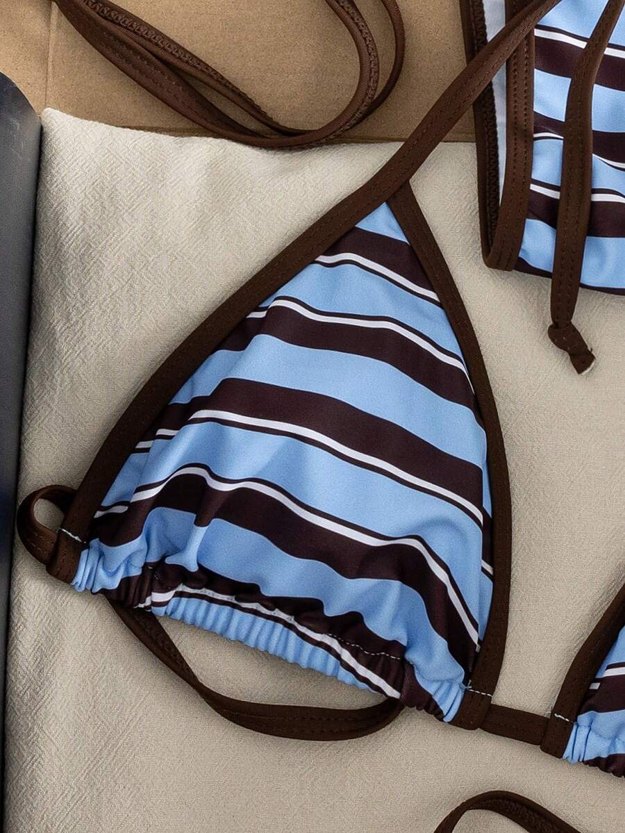 Women's two-piece halter triangle bikini set featuring a backless tie-back top with removable padding and matching tie-side mid-waist bottoms.