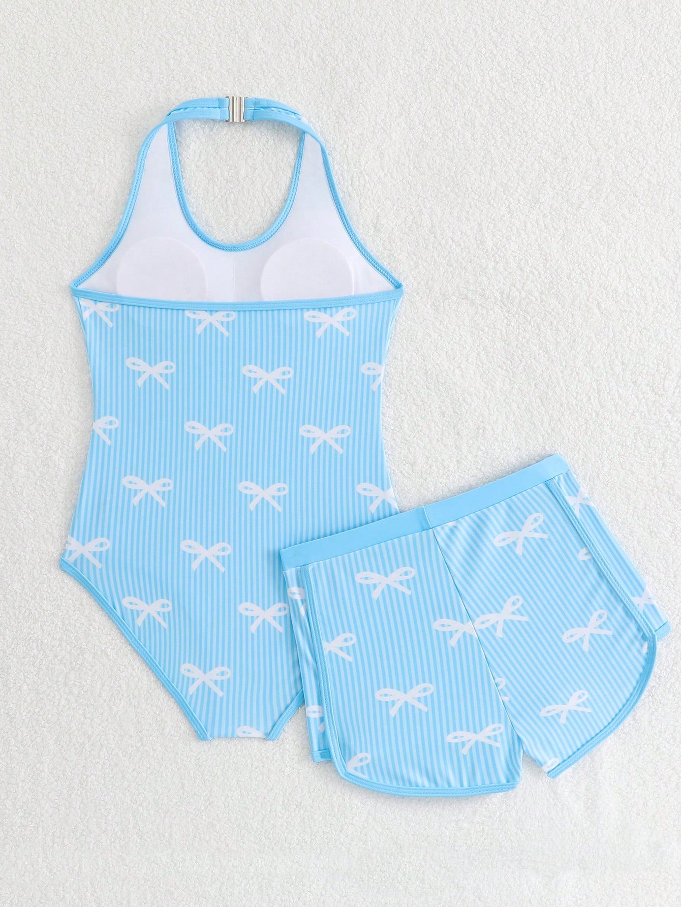 Girls 2-piece swimwear set featuring a butterfly print halter swimsuit top with contrast piping and separate mid-waist shorts; sleeveless, high-stretch, wireless design for beach and vacation wear.