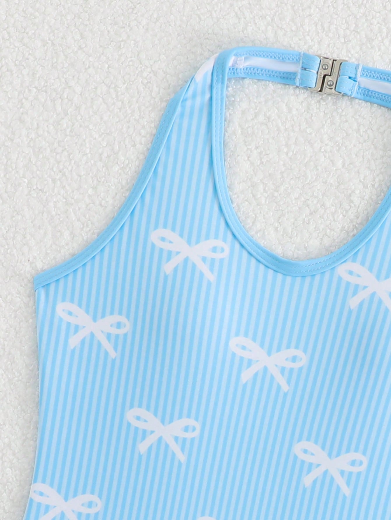 Girls 2-piece swimwear set featuring a butterfly print halter swimsuit top with contrast piping and separate mid-waist shorts; sleeveless, high-stretch, wireless design for beach and vacation wear.