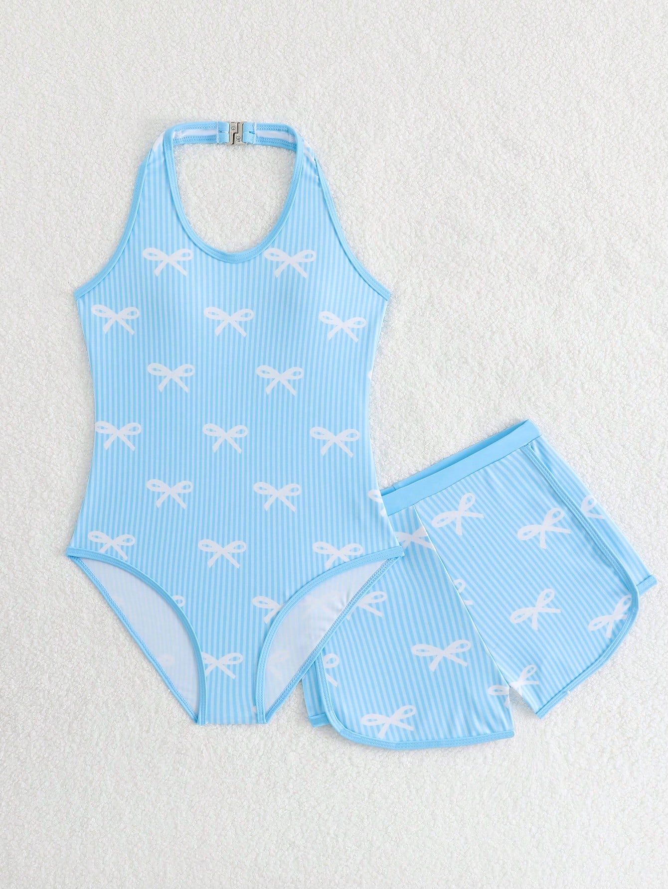 Girls 2-piece swimwear set featuring a butterfly print halter swimsuit top with contrast piping and separate mid-waist shorts; sleeveless, high-stretch, wireless design for beach and vacation wear.