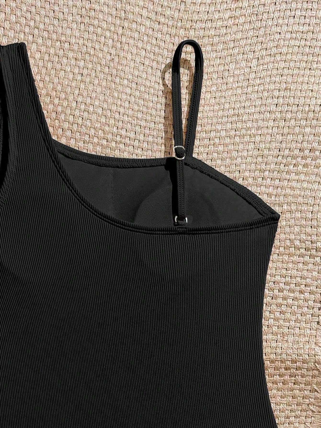 Tween girls one-piece swimsuit featuring an asymmetric neckline, pendant decor, plain design, wireless bra, high-cut bottom, and medium-stretch fabric.