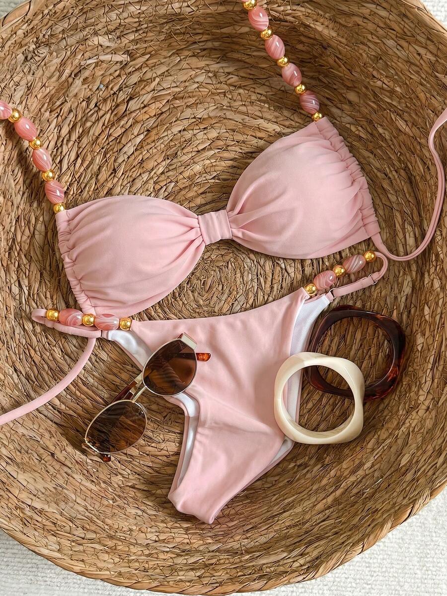 Women's green halter neck bikini set featuring color-block beaded shoulder straps, back tie detail, and high cut bottoms.
