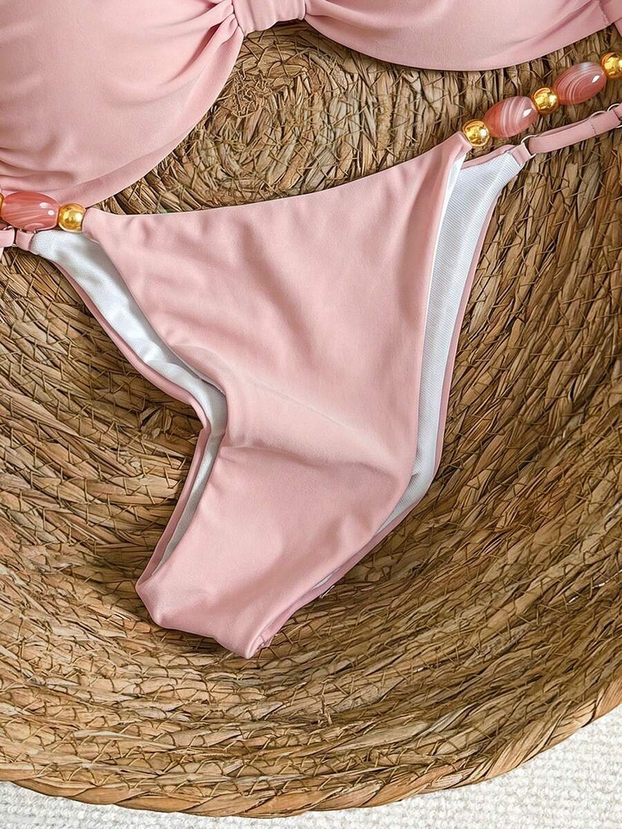 Women's green halter neck bikini set featuring color-block beaded shoulder straps, back tie detail, and high cut bottoms.
