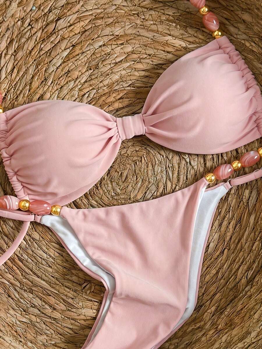 Women's green halter neck bikini set featuring color-block beaded shoulder straps, back tie detail, and high cut bottoms.