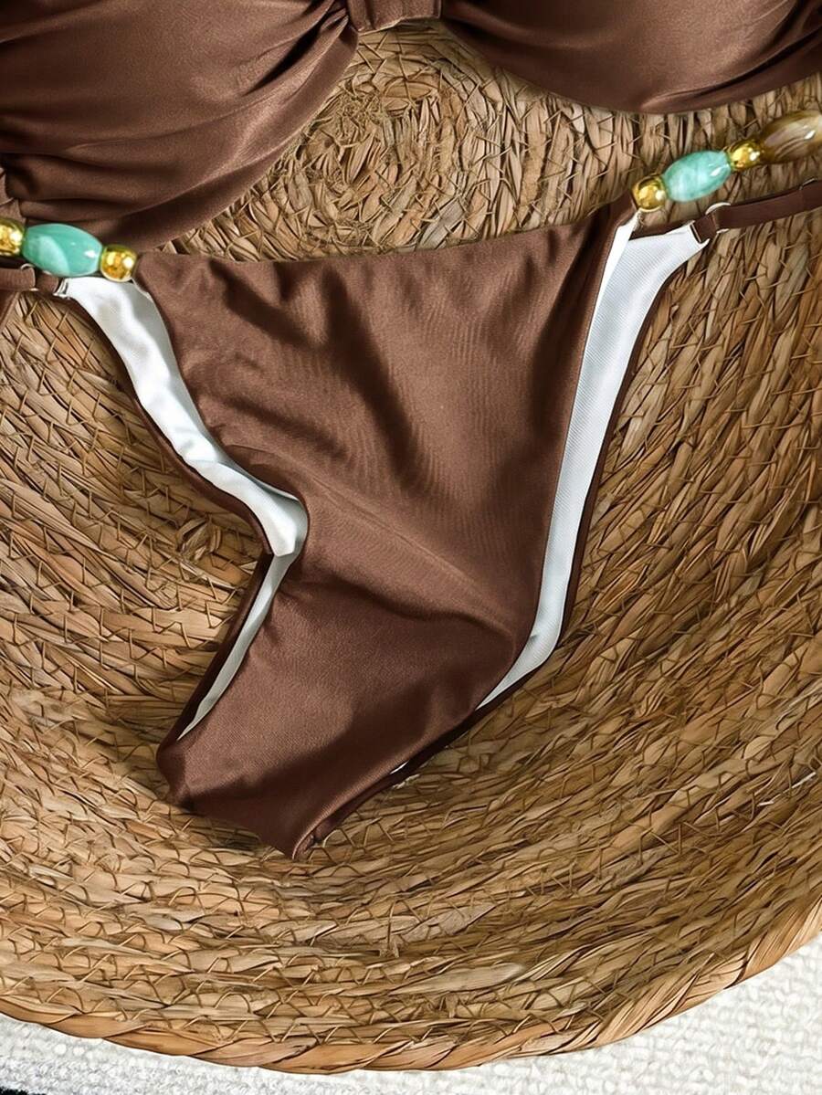 Women's green halter neck bikini set featuring color-block beaded shoulder straps, back tie detail, and high cut bottoms.