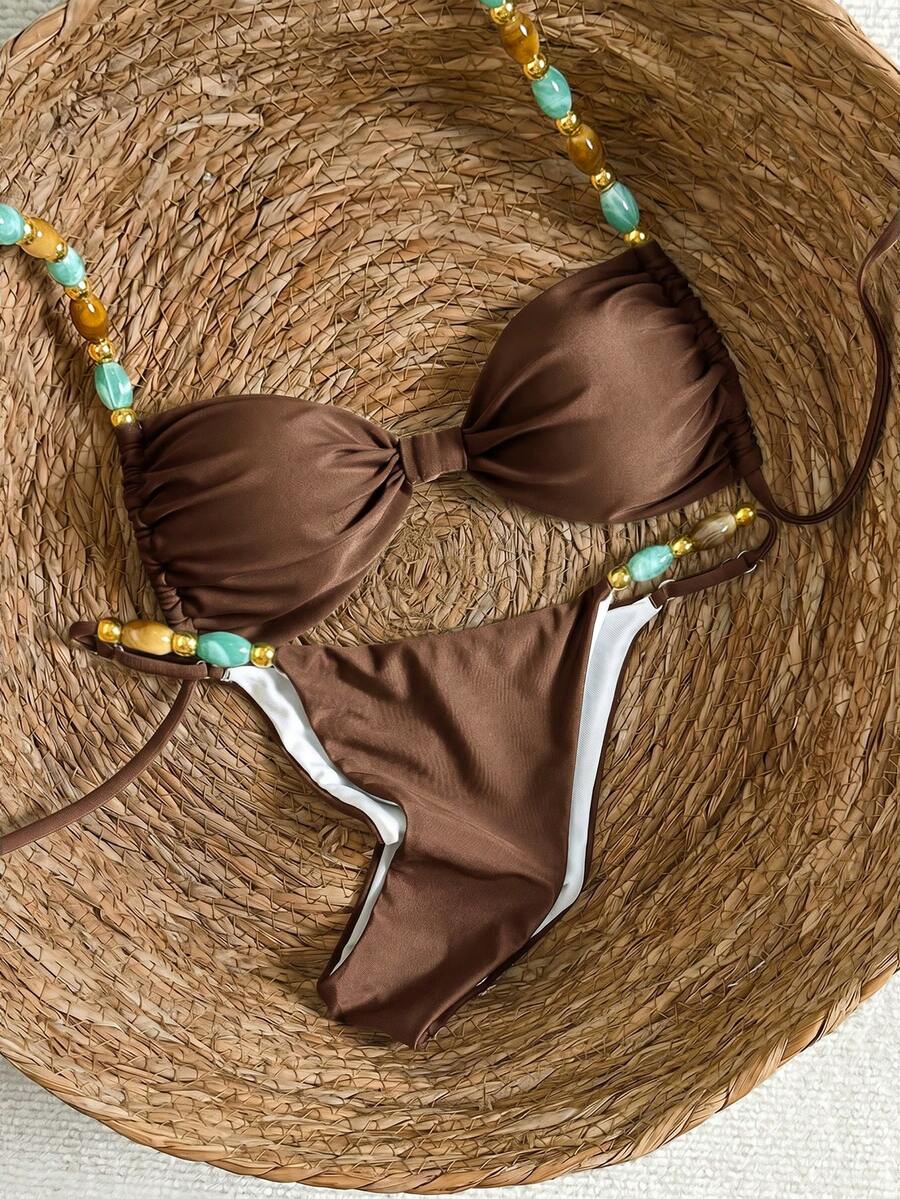 Women's green halter neck bikini set featuring color-block beaded shoulder straps, back tie detail, and high cut bottoms.