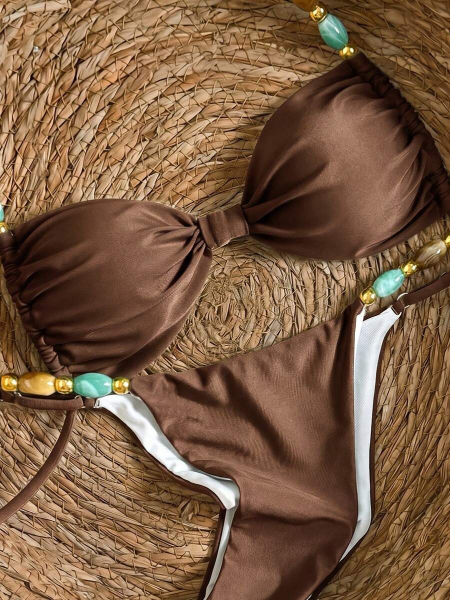 Women's green halter neck bikini set featuring color-block beaded shoulder straps, back tie detail, and high cut bottoms.
