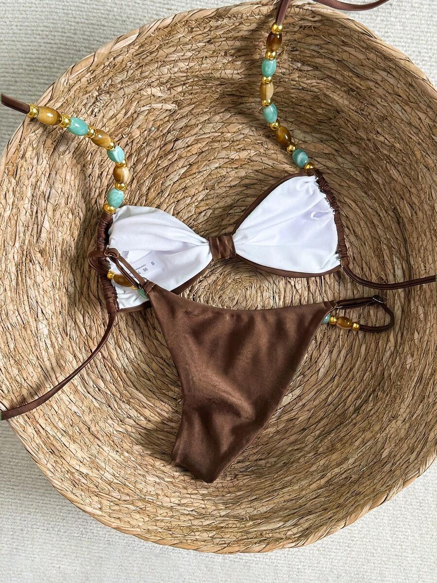 Women's green halter neck bikini set featuring color-block beaded shoulder straps, back tie detail, and high cut bottoms.