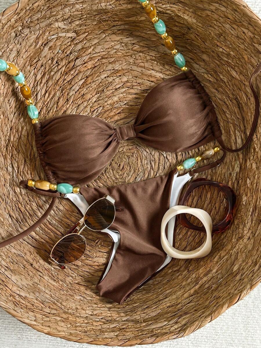 Women's green halter neck bikini set featuring color-block beaded shoulder straps, back tie detail, and high cut bottoms.