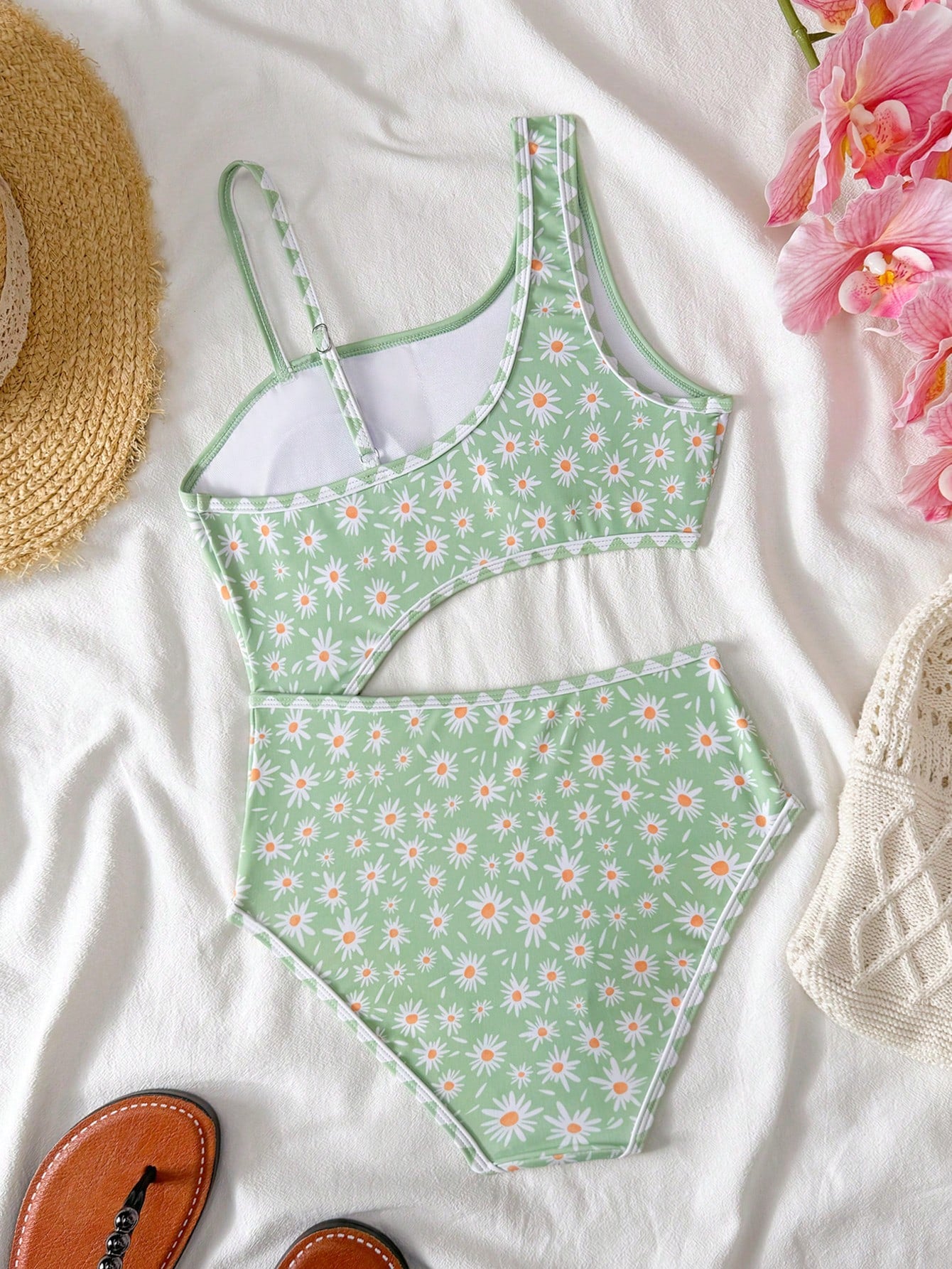 Tween girls one-piece swimsuit featuring an asymmetric neckline, pendant decor, plain design, wireless bra, high-cut bottom, and medium-stretch fabric.