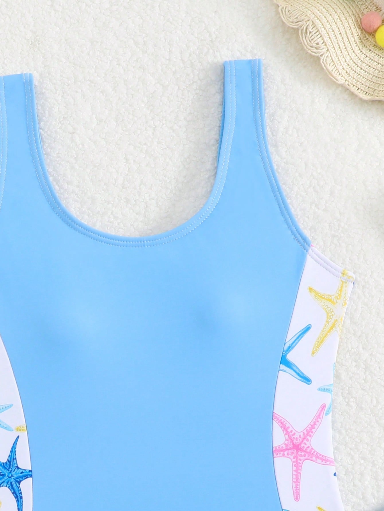 Tween girls 2-piece swimsuit set in black with full floral and plant print, featuring a sleeveless scoop-neck swim top and matching shorts-style bottoms.