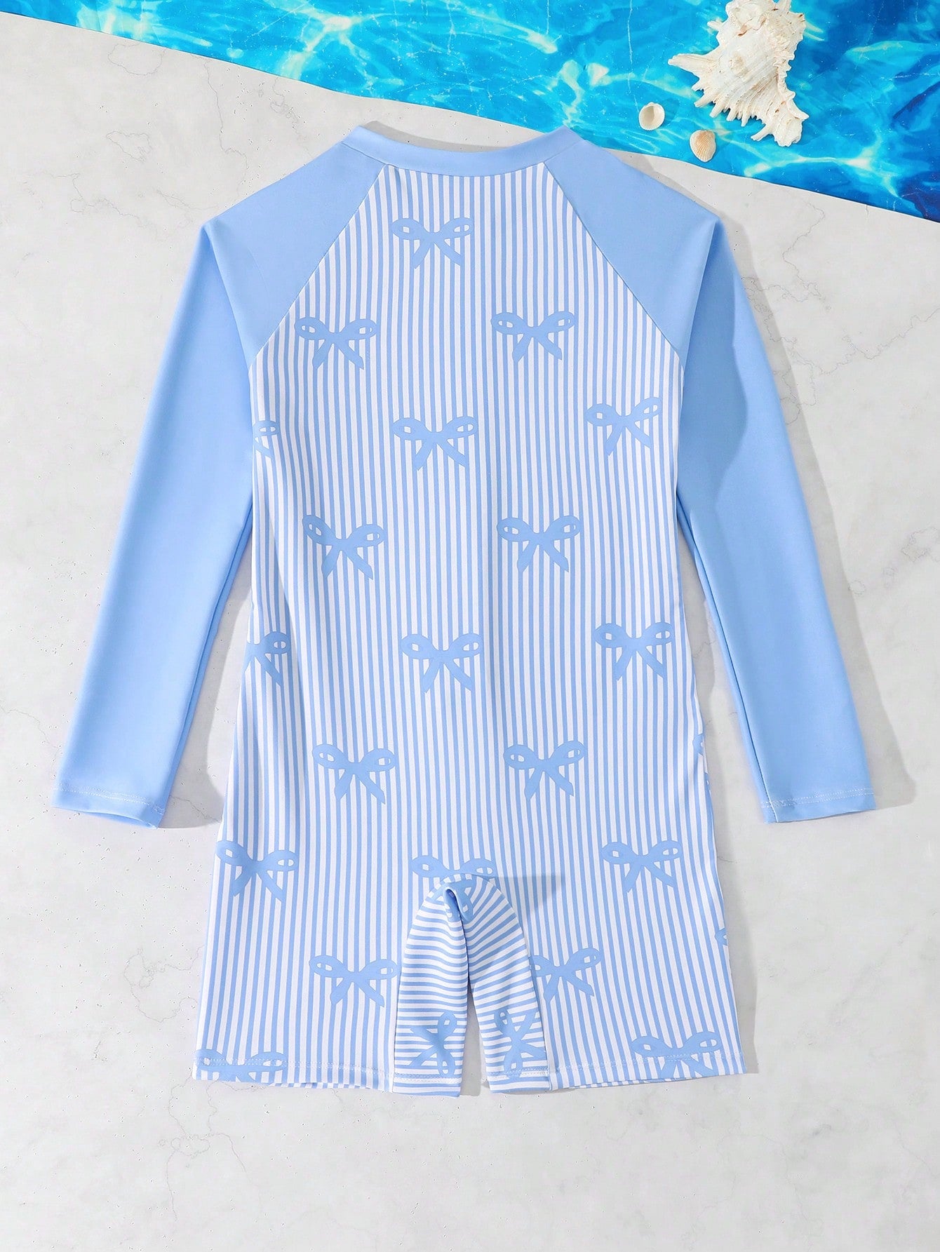 Tween girls one-piece swimsuit featuring a high neck, long sleeves, and shorts bottom, with a back zipper and strawberry plaid digital print on stretch knit fabric. Designed for swimming, vacation, and summer wear.