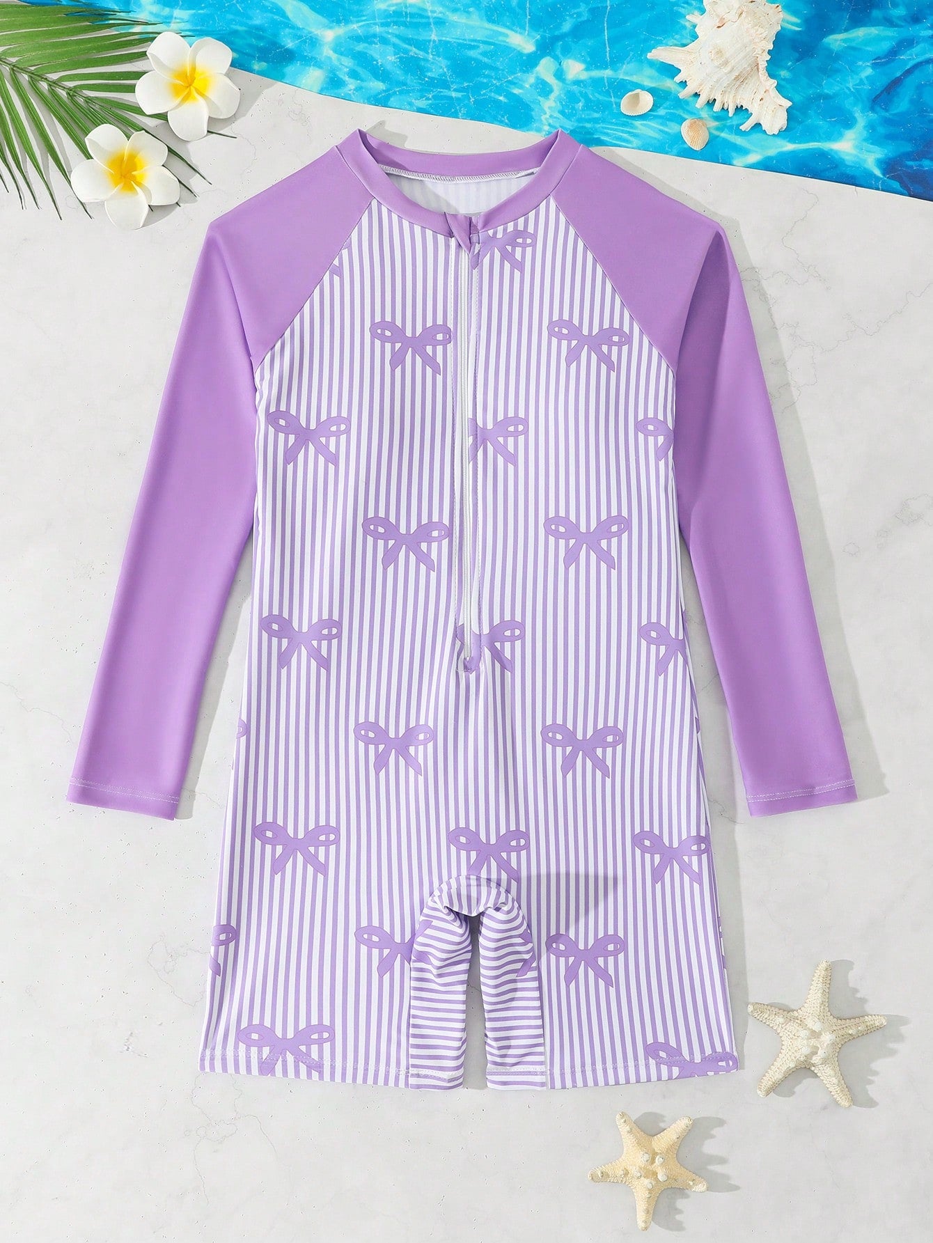 Tween girls one-piece swimsuit featuring a high neck, long sleeves, and shorts bottom, with a back zipper and strawberry plaid digital print on stretch knit fabric. Designed for swimming, vacation, and summer wear.