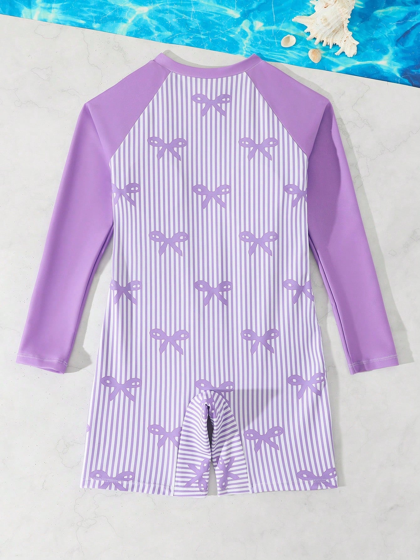 Tween girls one-piece swimsuit featuring a high neck, long sleeves, and shorts bottom, with a back zipper and strawberry plaid digital print on stretch knit fabric. Designed for swimming, vacation, and summer wear.