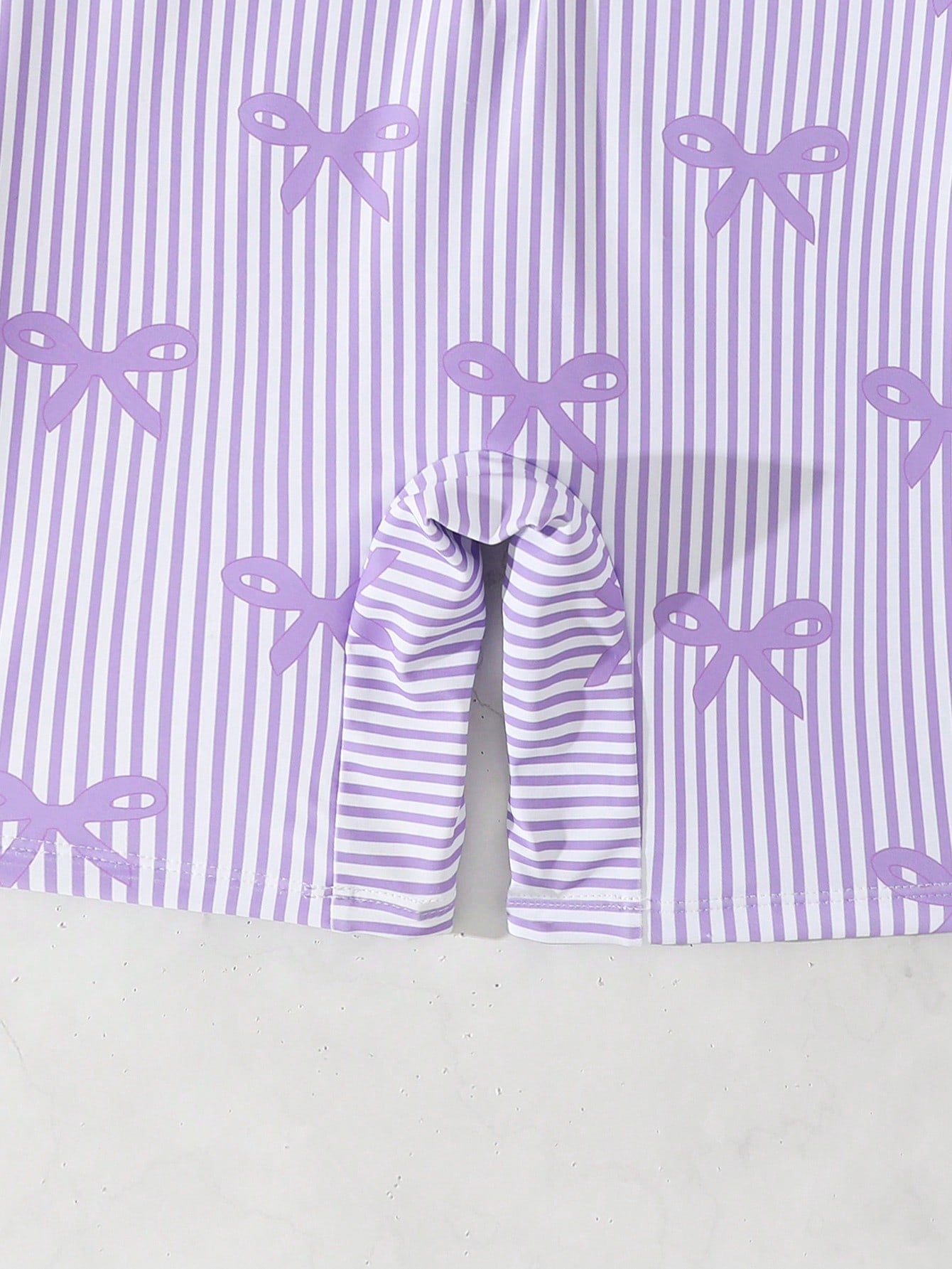 Tween girls one-piece swimsuit featuring a high neck, long sleeves, and shorts bottom, with a back zipper and strawberry plaid digital print on stretch knit fabric. Designed for swimming, vacation, and summer wear.