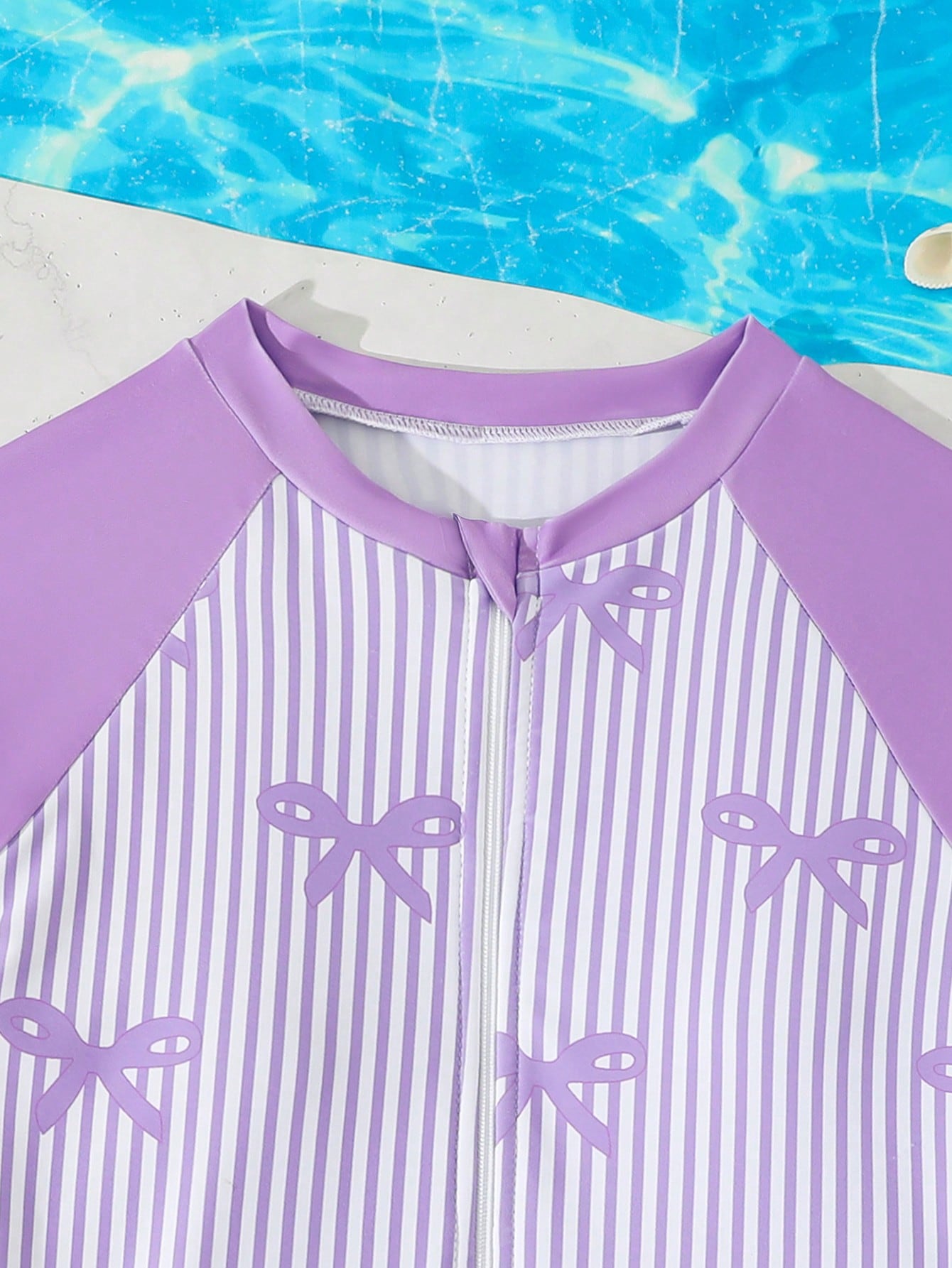 Tween girls one-piece swimsuit featuring a high neck, long sleeves, and shorts bottom, with a back zipper and strawberry plaid digital print on stretch knit fabric. Designed for swimming, vacation, and summer wear.