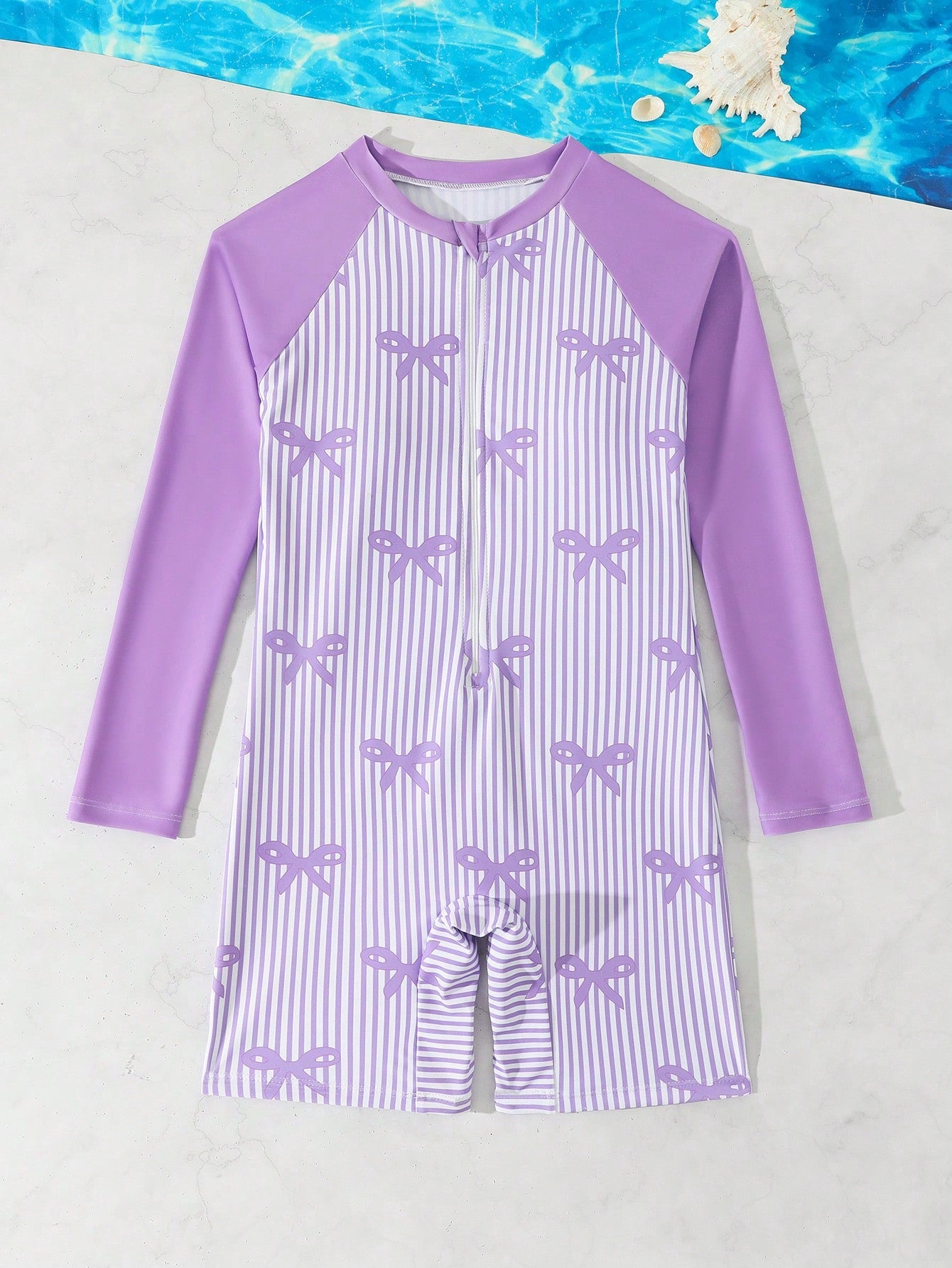 Tween girls one-piece swimsuit featuring a high neck, long sleeves, and shorts bottom, with a back zipper and strawberry plaid digital print on stretch knit fabric. Designed for swimming, vacation, and summer wear.