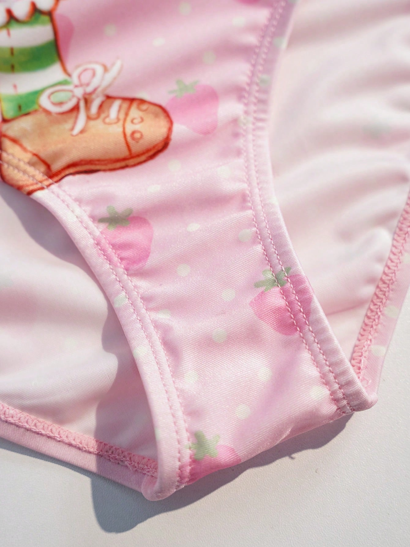 Pink tween girls one-piece swimsuit with ruffle details, spaghetti straps, plant pattern, and matching cover-up skirt set for summer beach wear