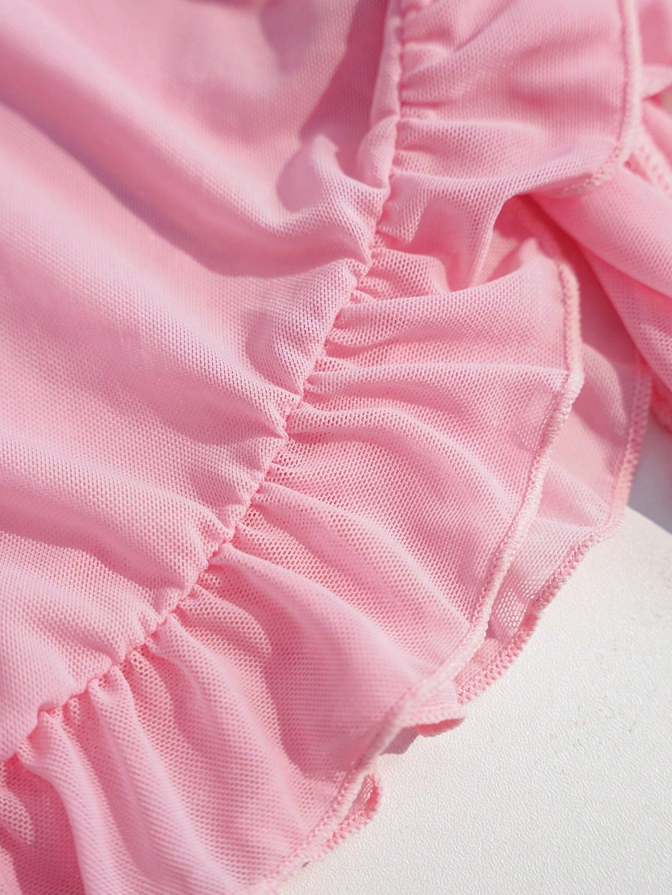 Pink tween girls one-piece swimsuit with ruffle details, spaghetti straps, plant pattern, and matching cover-up skirt set for summer beach wear
