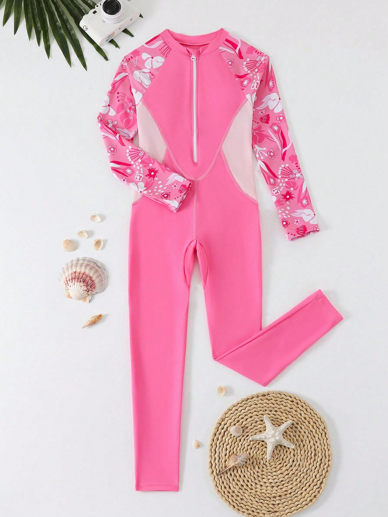 Tween girls black one-piece swimsuit with long sleeves, high neck, zipper detail, graphic leopard heart print, and fitted full-coverage swimwear style.