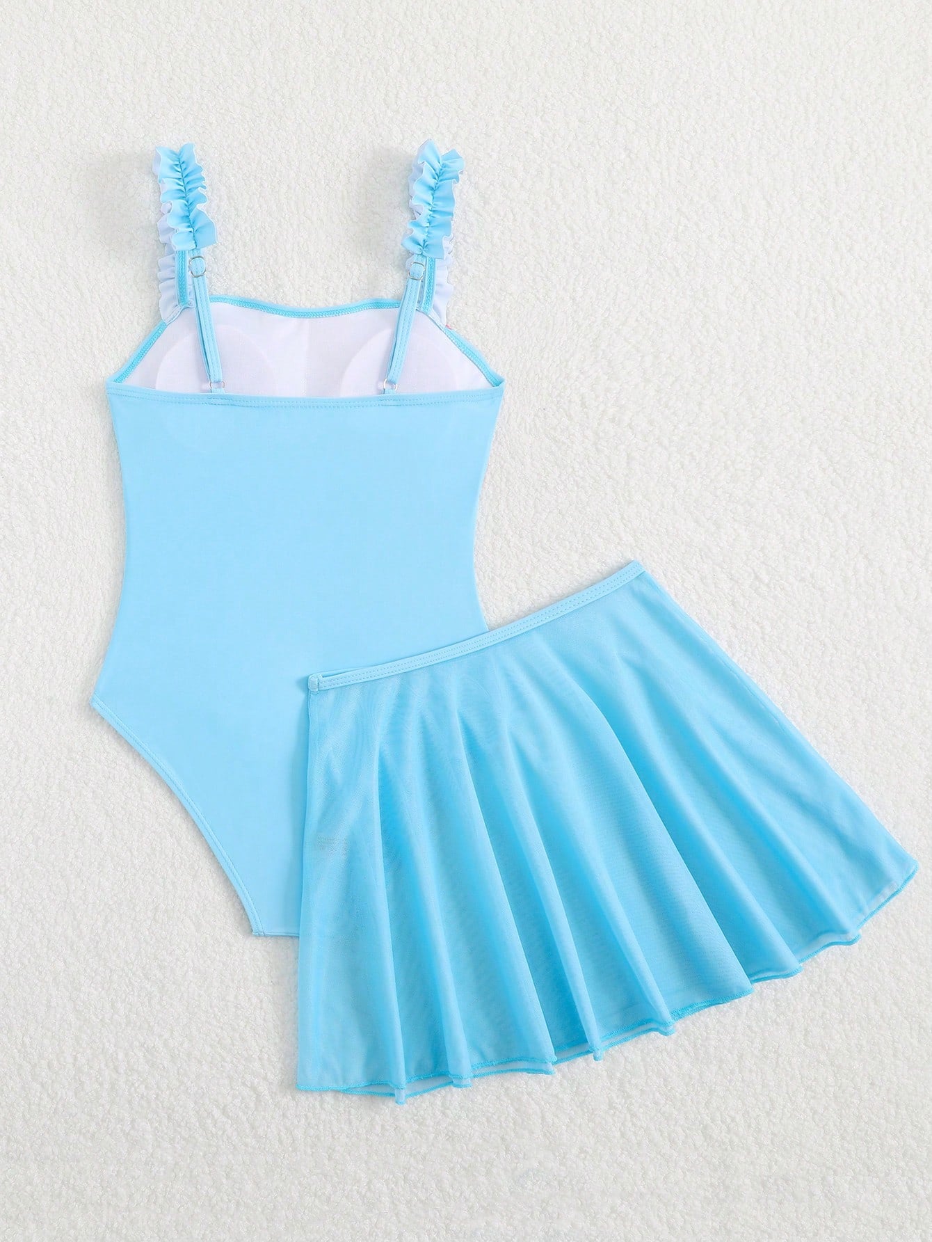 Girls floral print swimsuit set with strap neckline, sleeveless fitted top, and pleated mesh skirt bottom for beach and summer vacation wear.