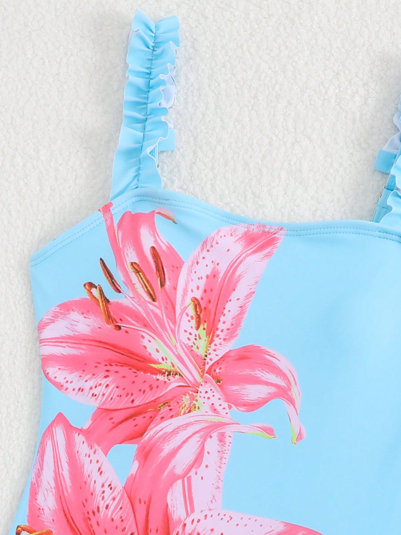 Girls floral print swimsuit set with strap neckline, sleeveless fitted top, and pleated mesh skirt bottom for beach and summer vacation wear.