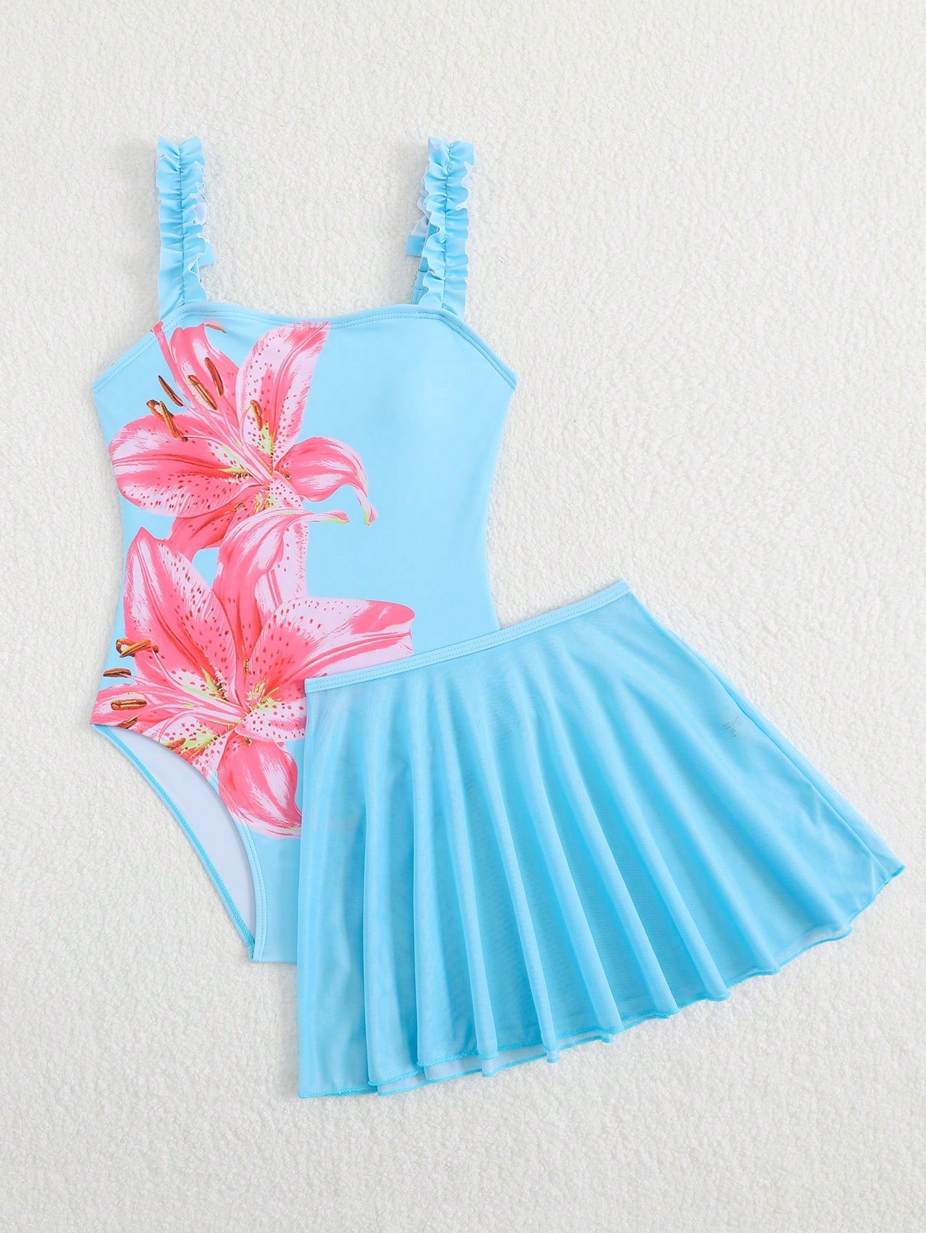 Girls floral print swimsuit set with strap neckline, sleeveless fitted top, and pleated mesh skirt bottom for beach and summer vacation wear.