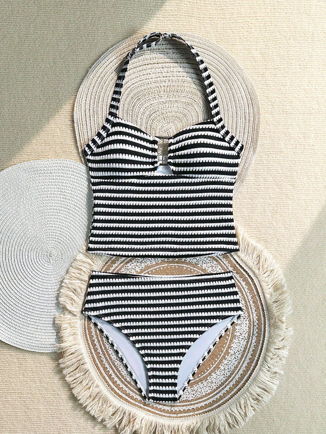 Two-piece tween girls swimwear set in pink with a wavy striped pattern and metallic decor, featuring a halter sleeveless top and mid-waist bottoms in soft, medium-stretch knit fabric, suitable for beach or pool wear.