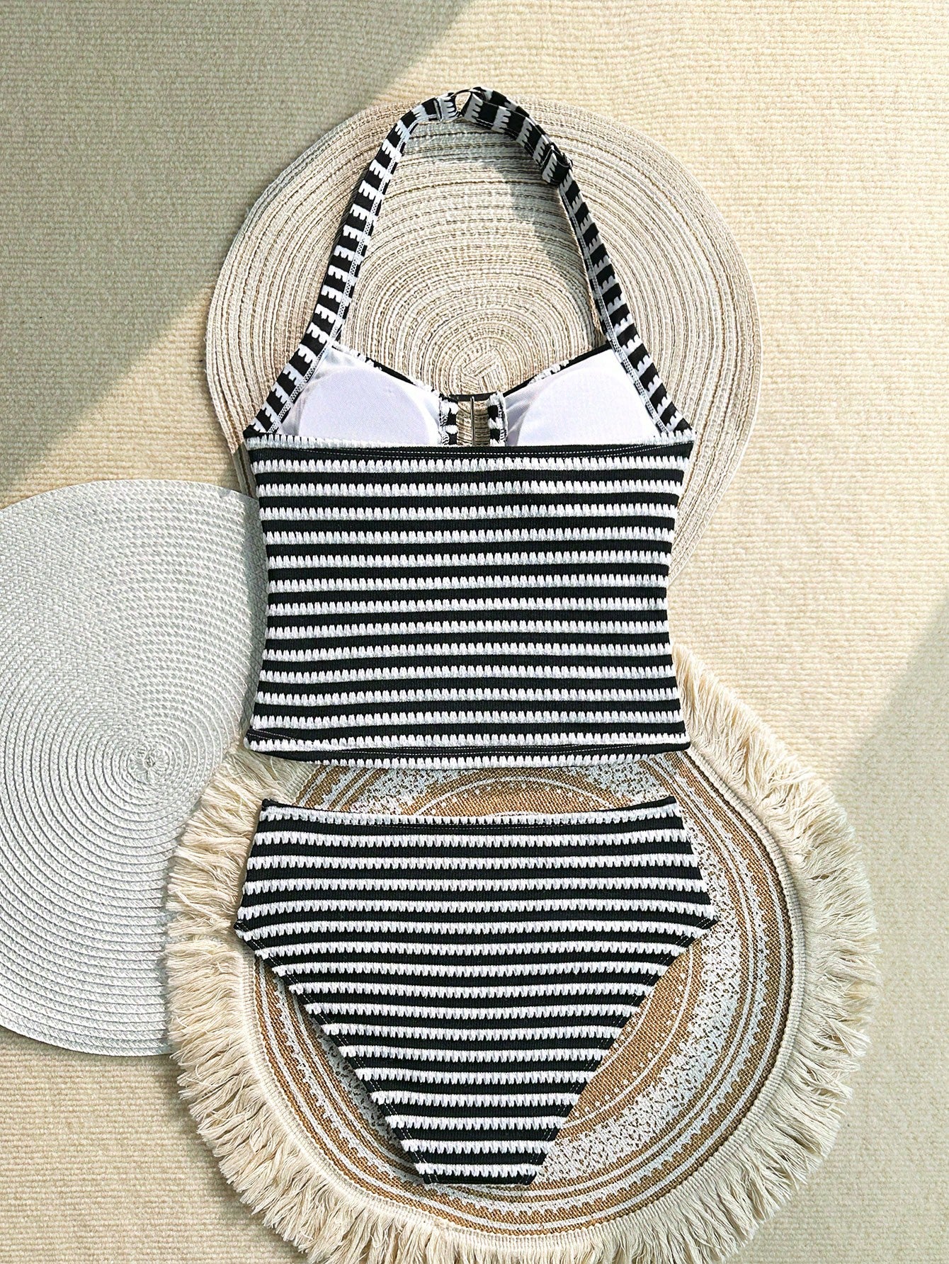 Two-piece tween girls swimwear set in pink with a wavy striped pattern and metallic decor, featuring a halter sleeveless top and mid-waist bottoms in soft, medium-stretch knit fabric, suitable for beach or pool wear.