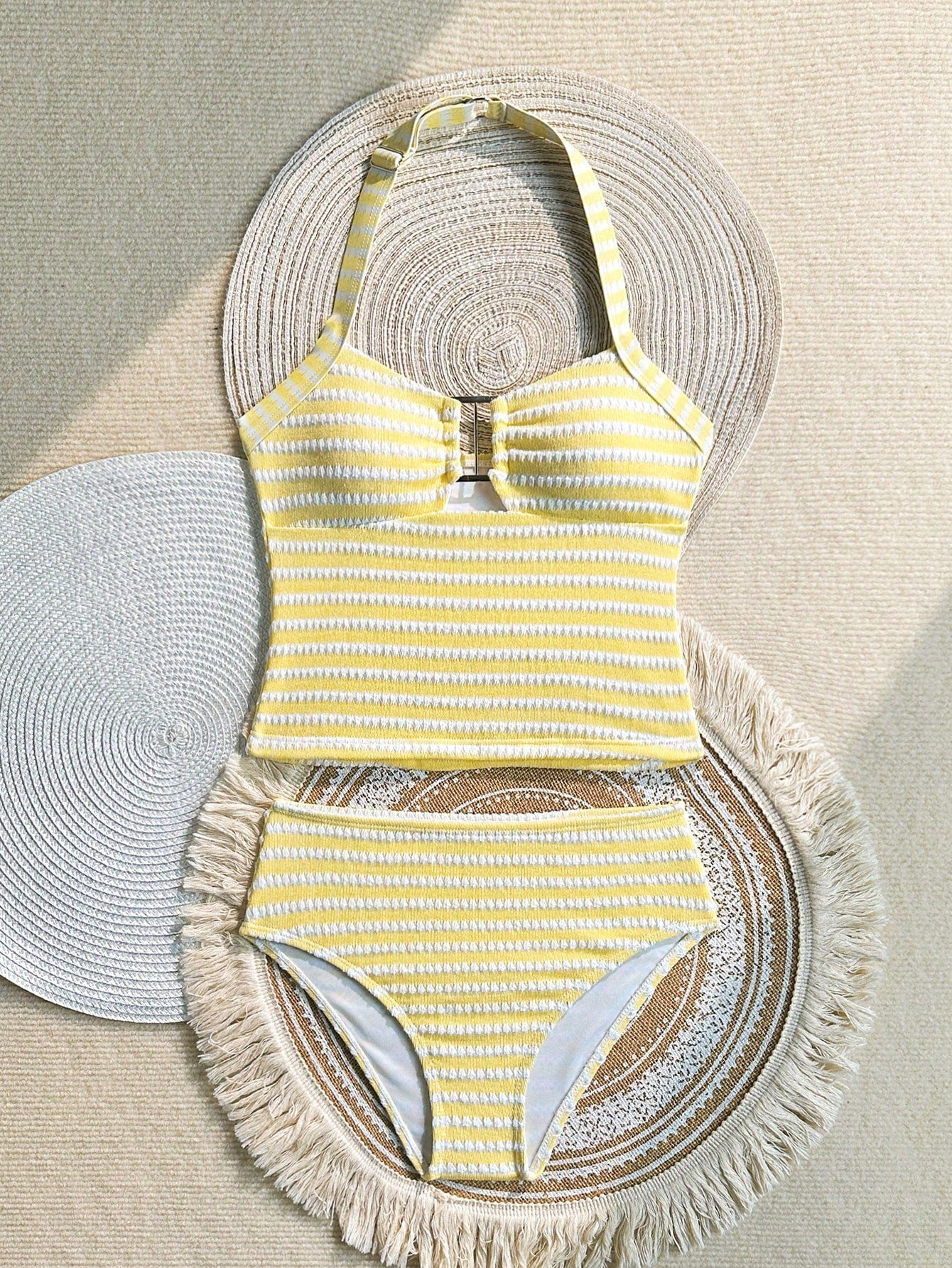Two-piece tween girls swimwear set in pink with a wavy striped pattern and metallic decor, featuring a halter sleeveless top and mid-waist bottoms in soft, medium-stretch knit fabric, suitable for beach or pool wear.