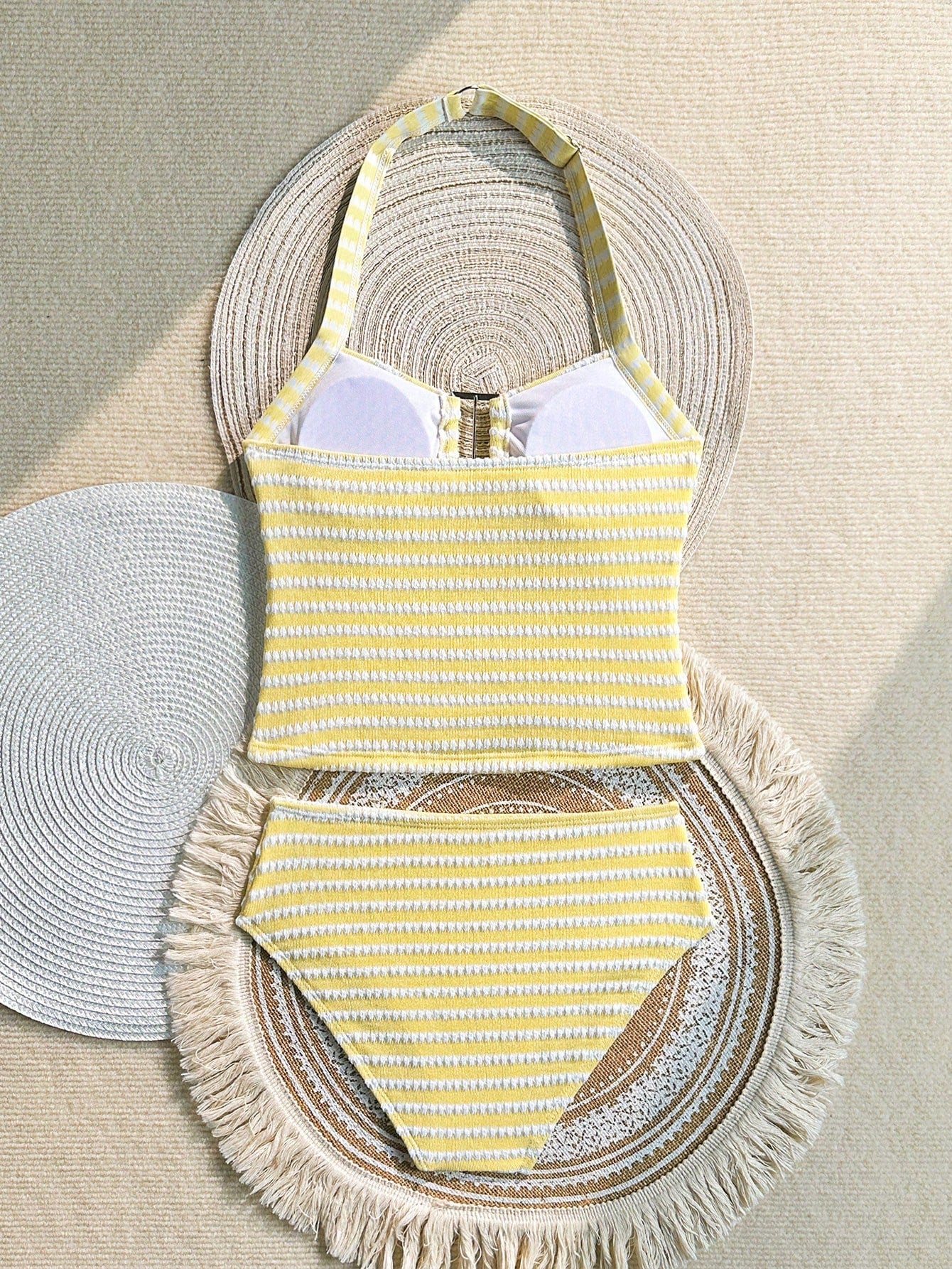 Two-piece tween girls swimwear set in pink with a wavy striped pattern and metallic decor, featuring a halter sleeveless top and mid-waist bottoms in soft, medium-stretch knit fabric, suitable for beach or pool wear.