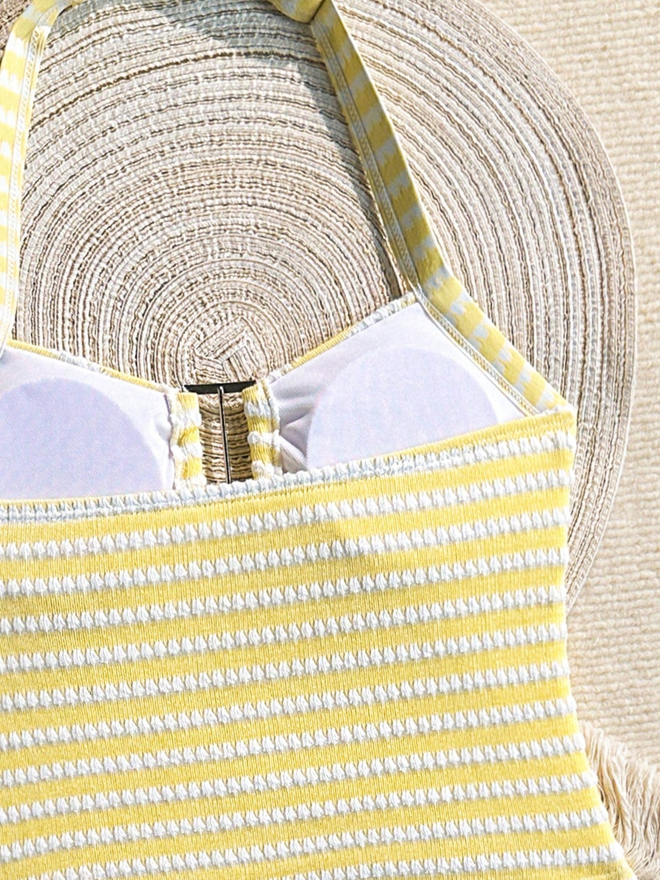 Two-piece tween girls swimwear set in pink with a wavy striped pattern and metallic decor, featuring a halter sleeveless top and mid-waist bottoms in soft, medium-stretch knit fabric, suitable for beach or pool wear.