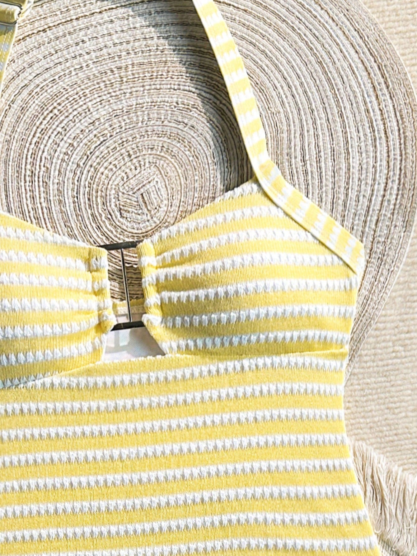 Two-piece tween girls swimwear set in pink with a wavy striped pattern and metallic decor, featuring a halter sleeveless top and mid-waist bottoms in soft, medium-stretch knit fabric, suitable for beach or pool wear.