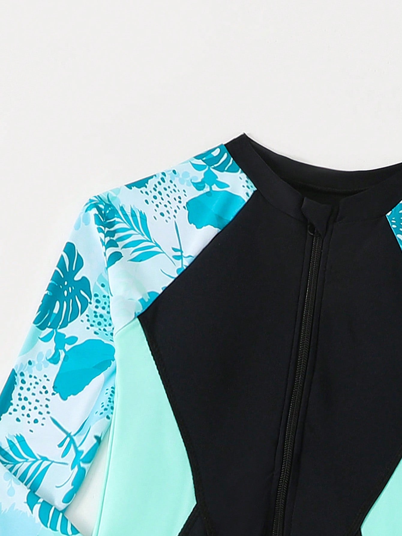 Tween girls black one-piece swimsuit with long sleeves, high neck, zipper detail, graphic leopard heart print, and fitted full-coverage swimwear style.