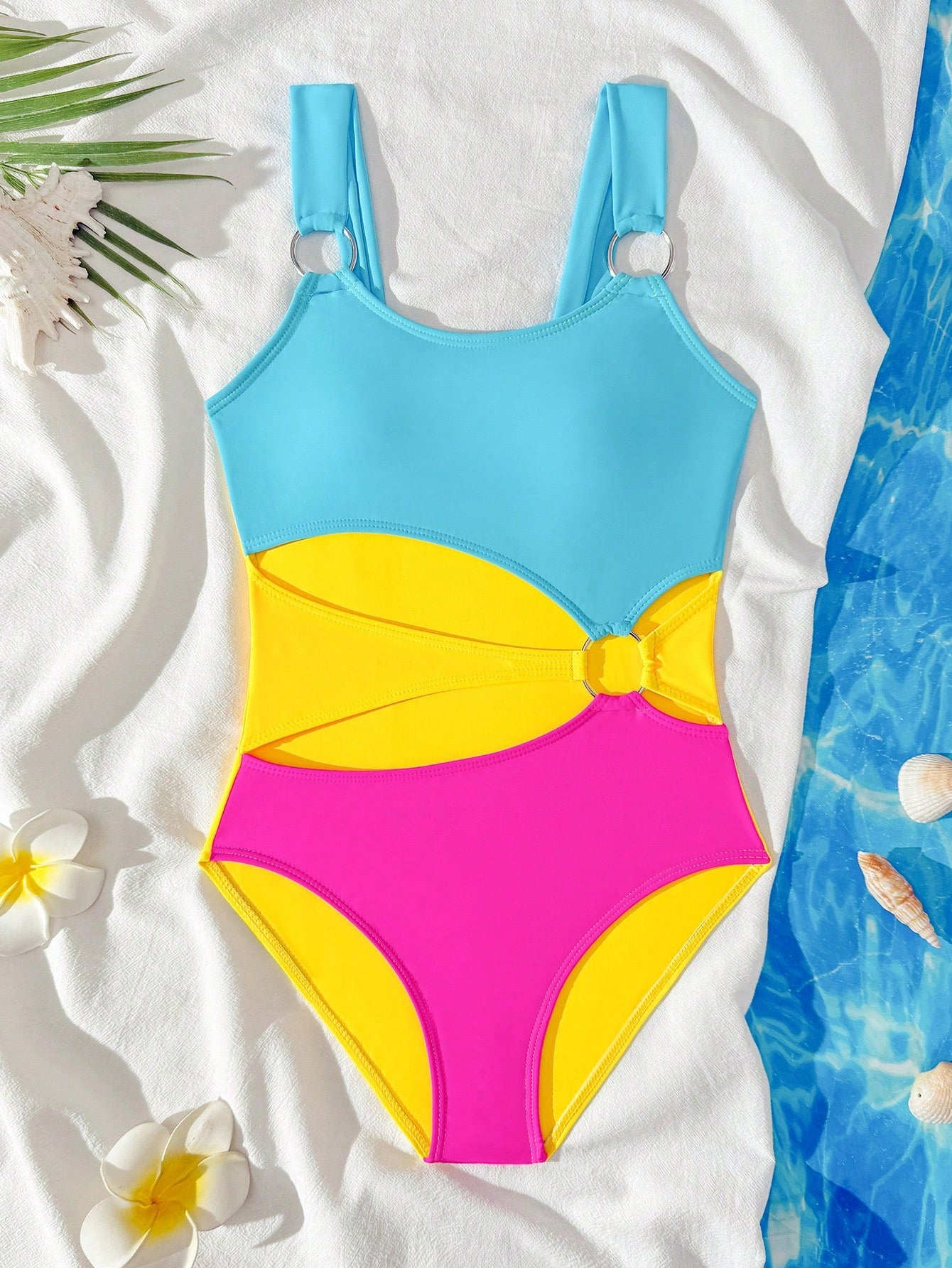 Black one-piece swimsuit for tween girls with cut out detail, spaghetti straps, high waist bottom, wireless bra, and fitted vacation swimwear style.