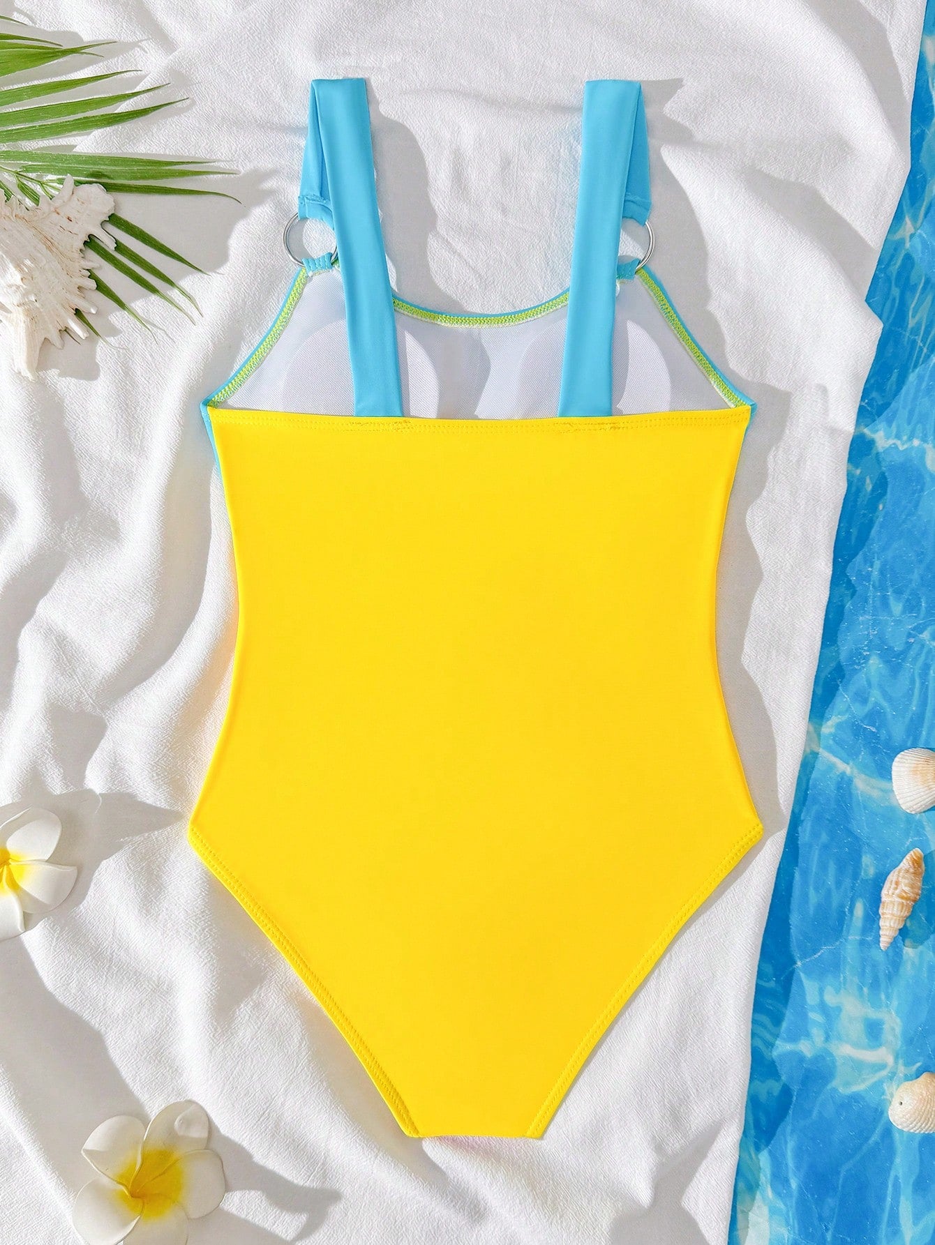 Black one-piece swimsuit for tween girls with cut out detail, spaghetti straps, high waist bottom, wireless bra, and fitted vacation swimwear style.