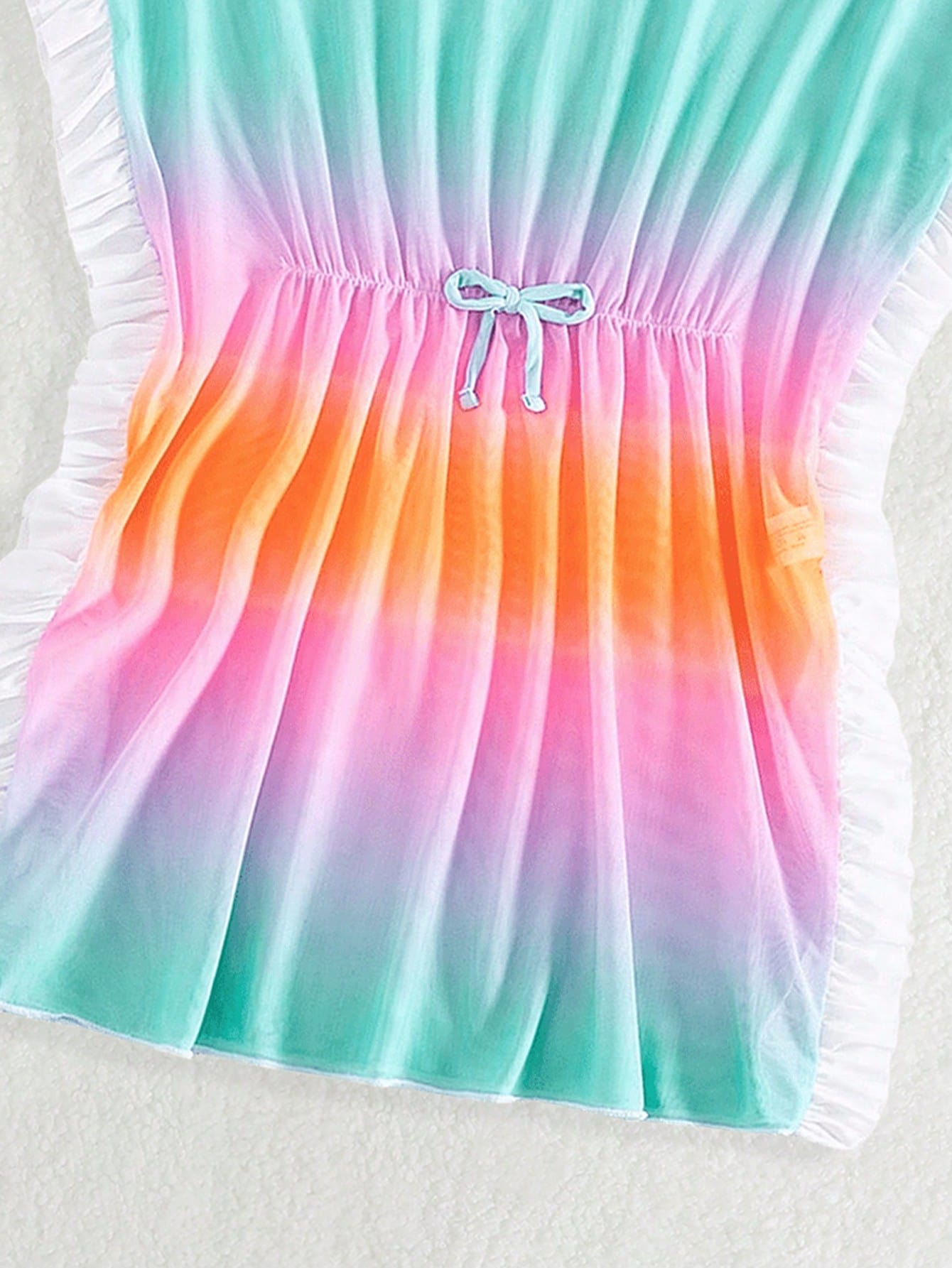 Blue tween girls swimsuit cover up with geometric starfish print, ruffle trim, round neck, short sleeves, and semi-sheer knit fabric for beach or pool wear.