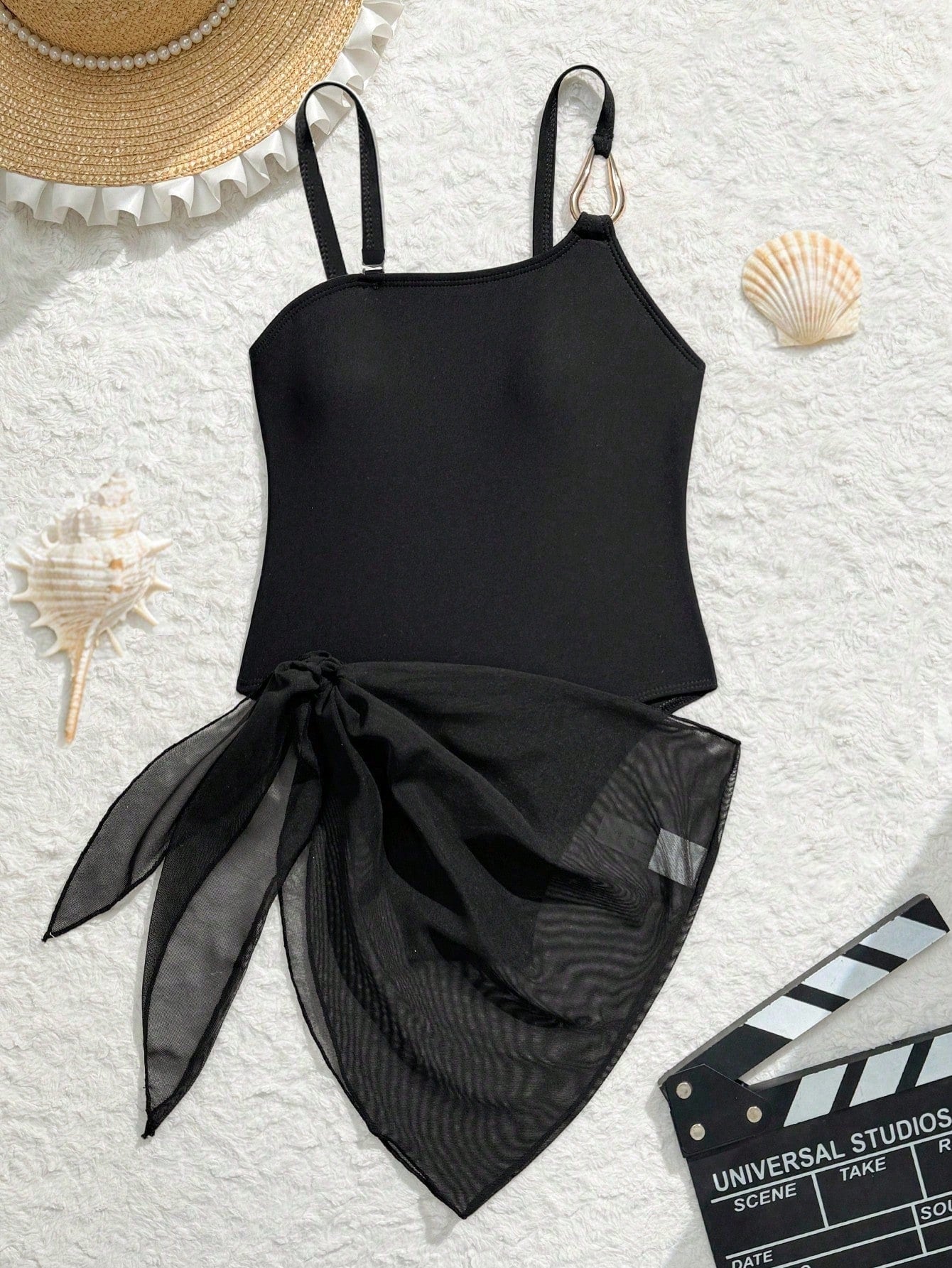 Black girls' one-piece swimsuit with spaghetti straps, plain design, and short asymmetrical mesh ruffle skirt for beach or vacation wear