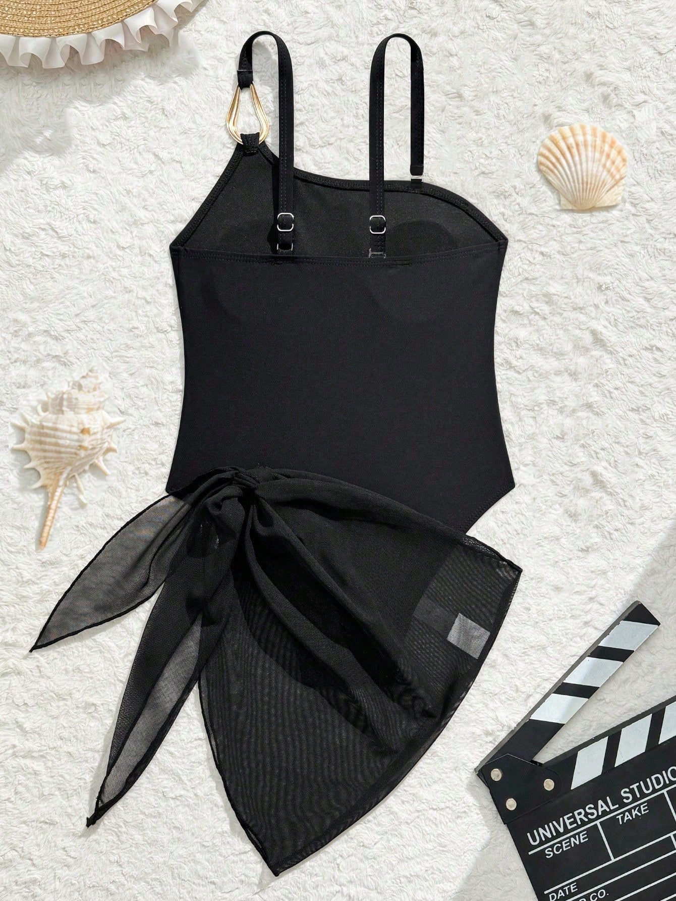 Black girls' one-piece swimsuit with spaghetti straps, plain design, and short asymmetrical mesh ruffle skirt for beach or vacation wear