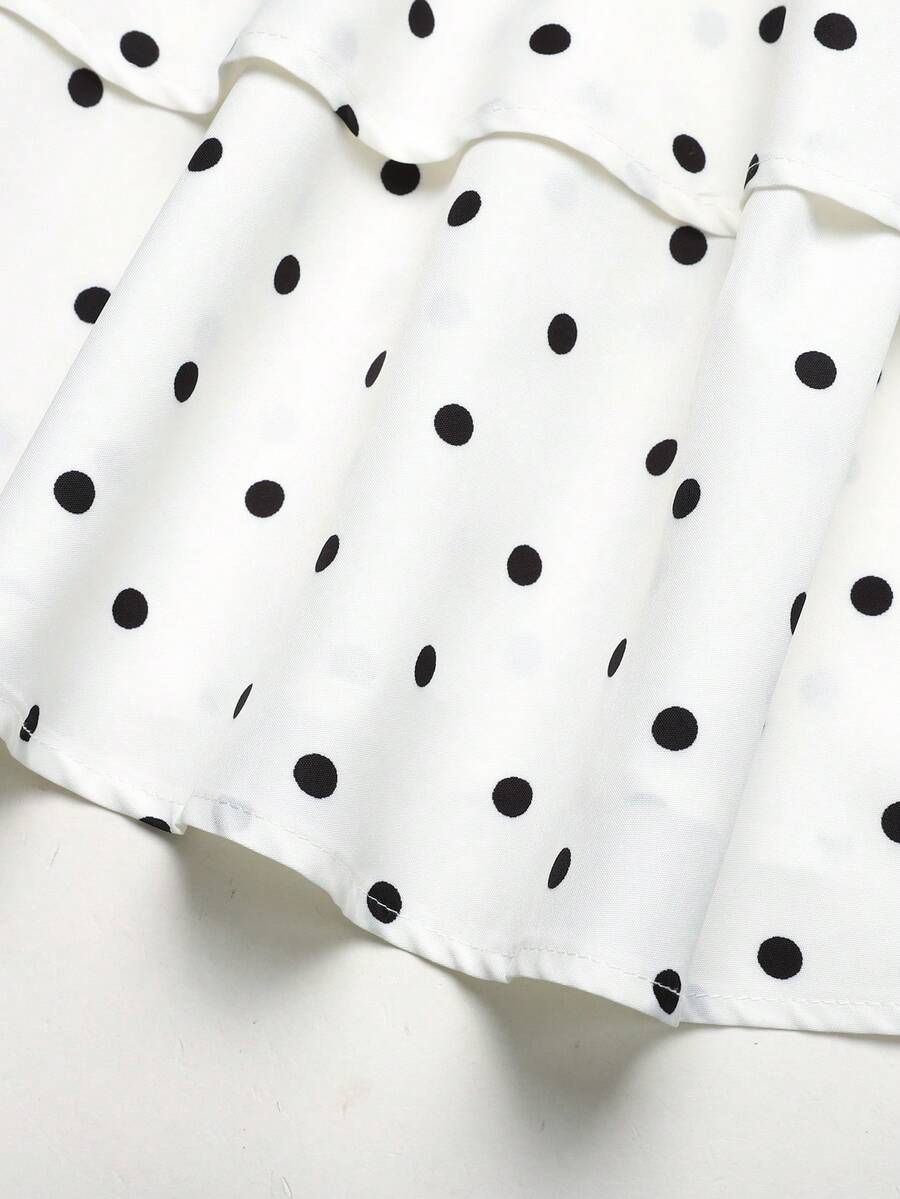 Black and white polka dot cami dress for tween girls featuring sleeveless straps, a shirred high waist, flared hem, and slim fit silhouette.